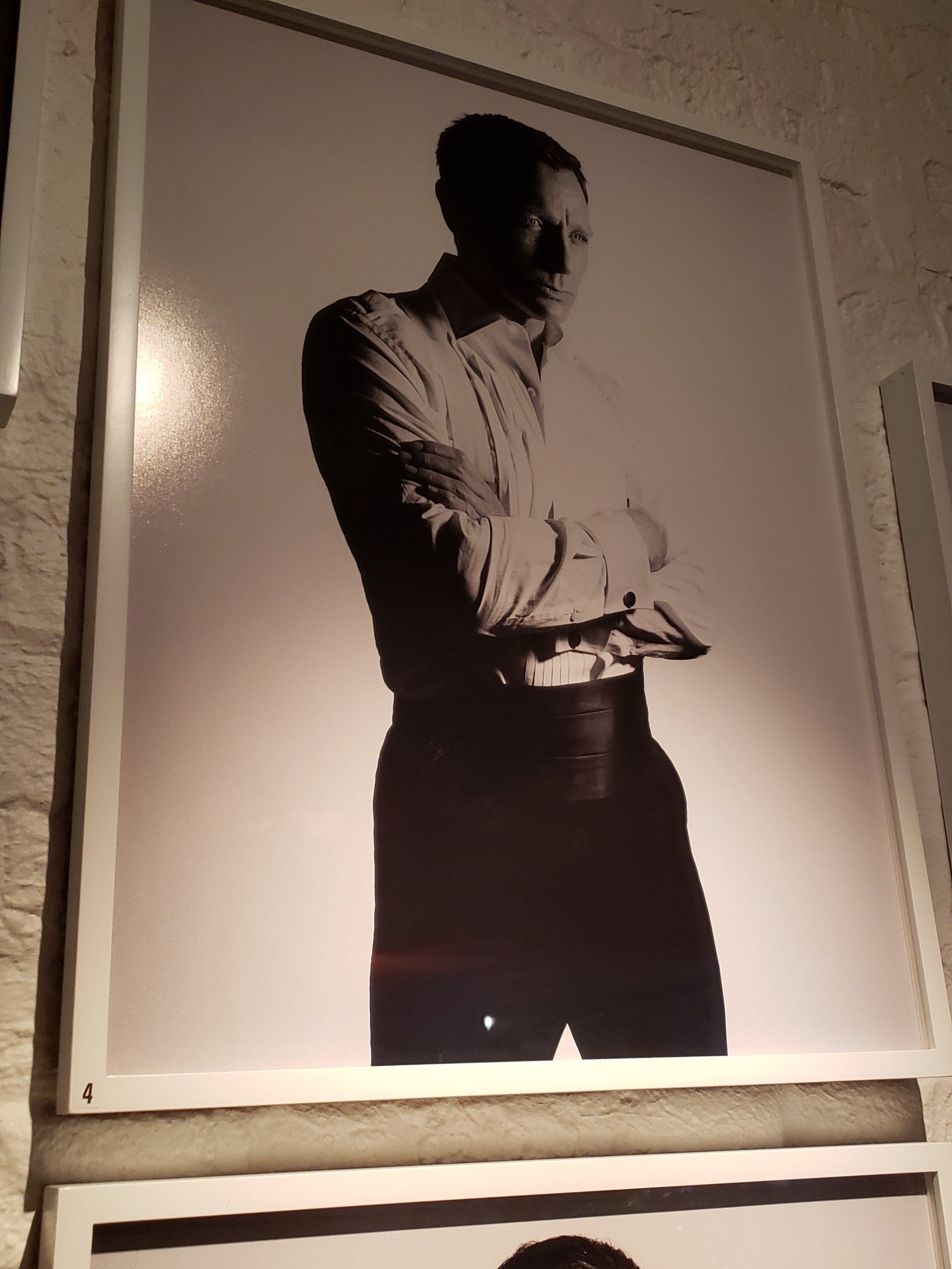 A black and white photo of a man with his arms crossed