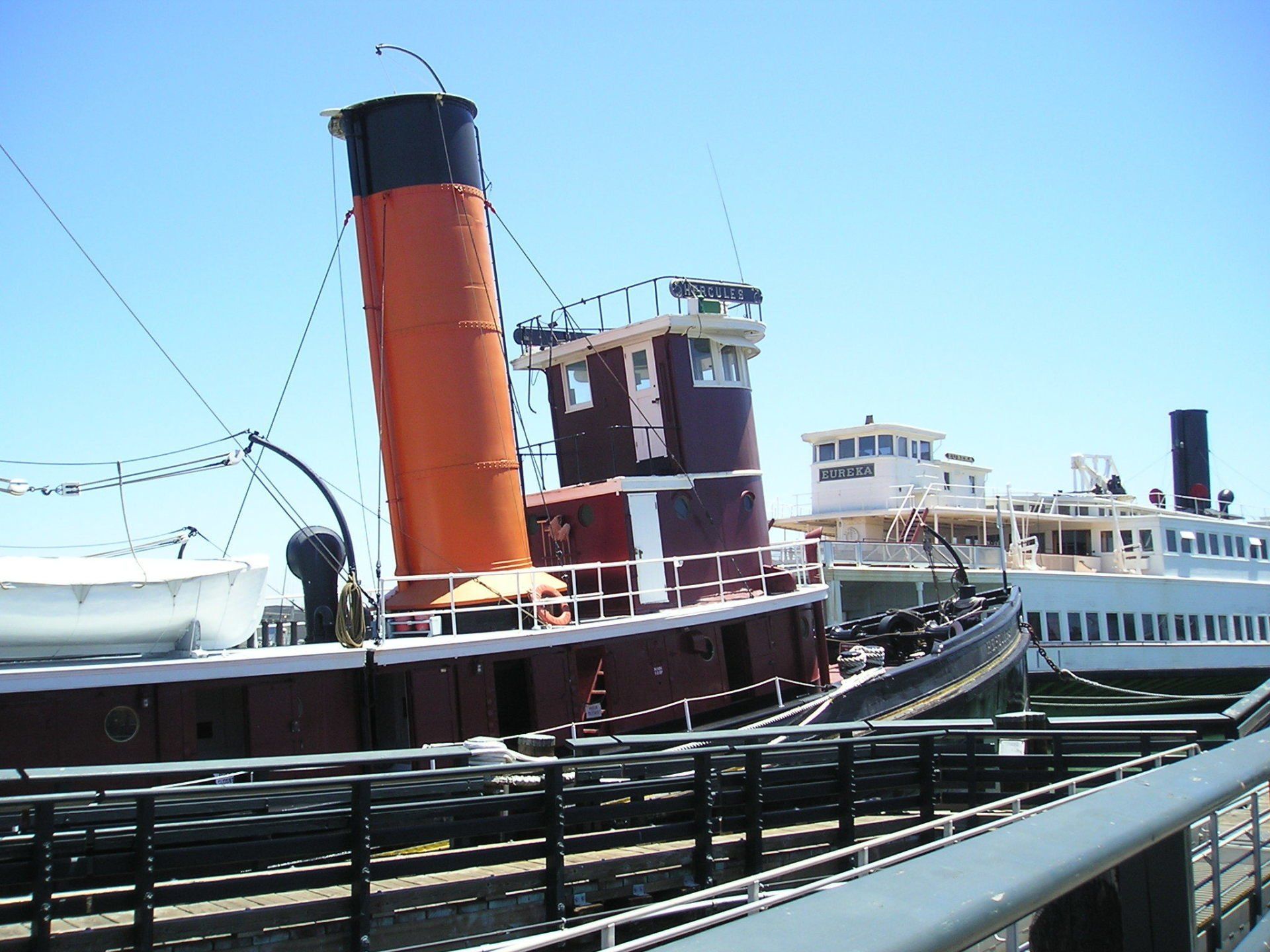 A large ship with a large orange chimney on top of it