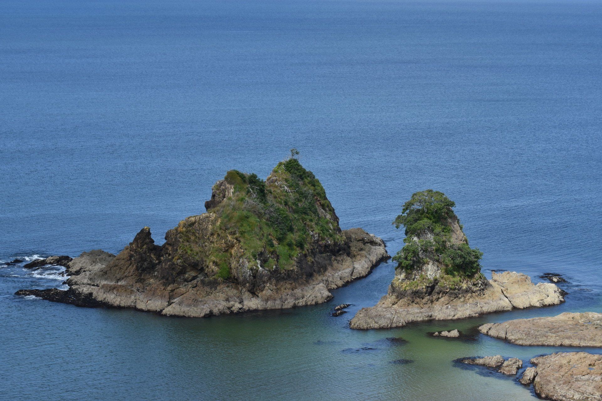 There are two small islands in the middle of the ocean.