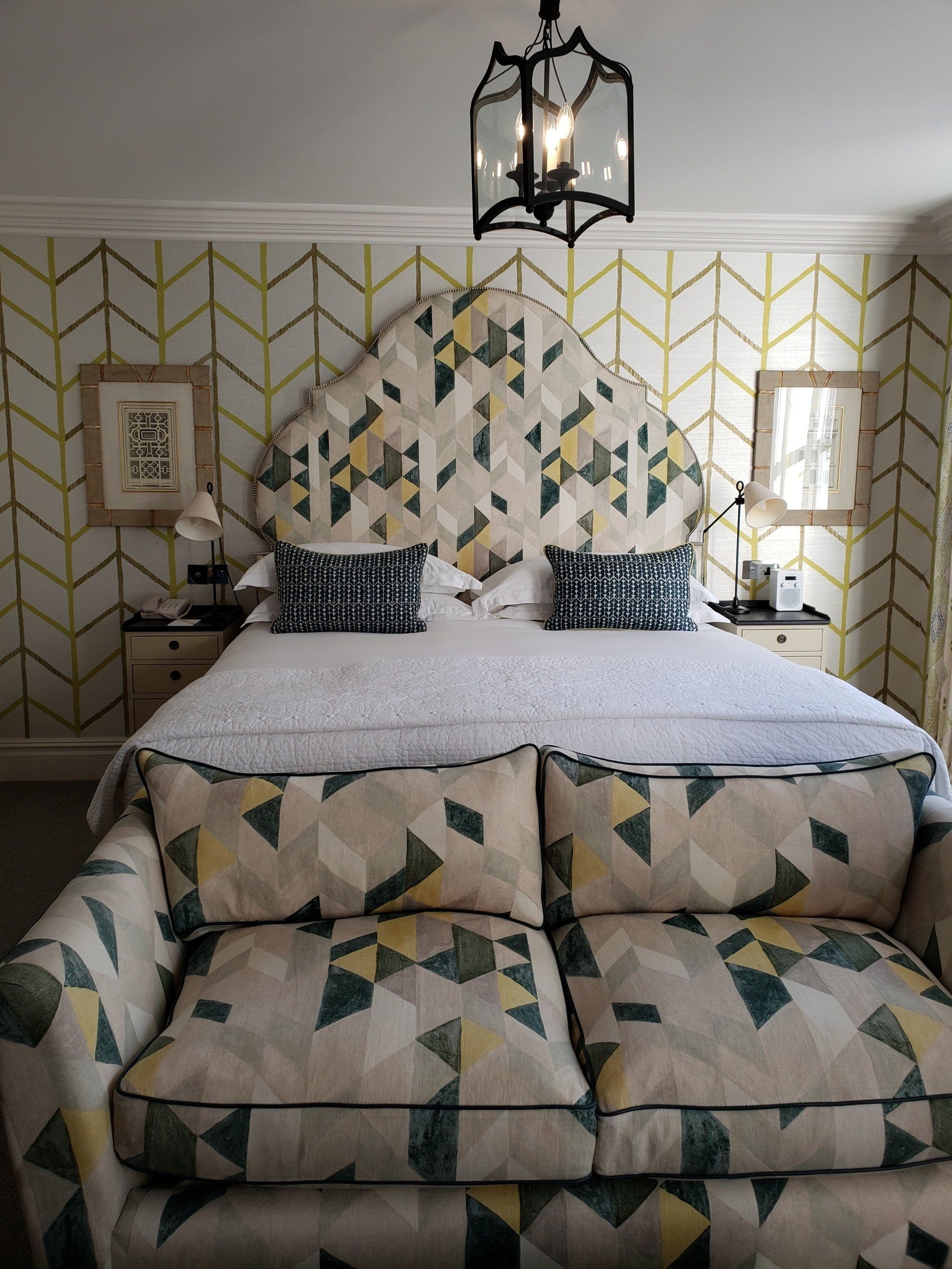 A bedroom with a large bed and a couch