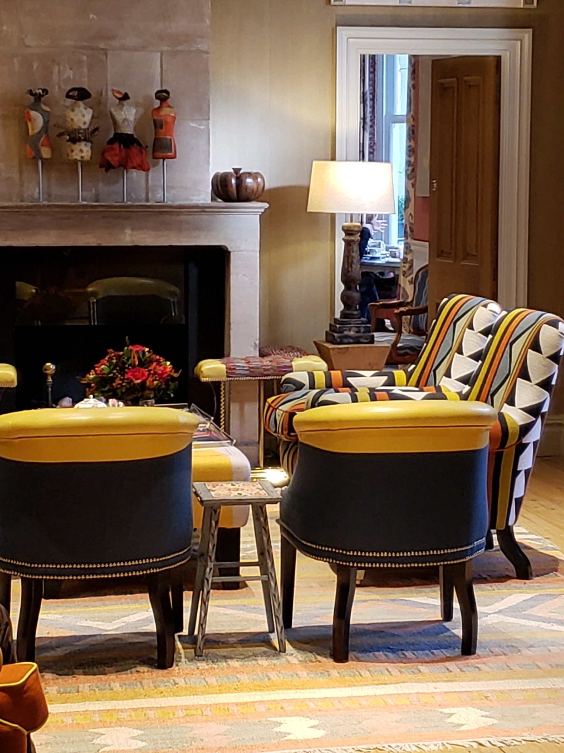 A living room with two chairs and a fireplace