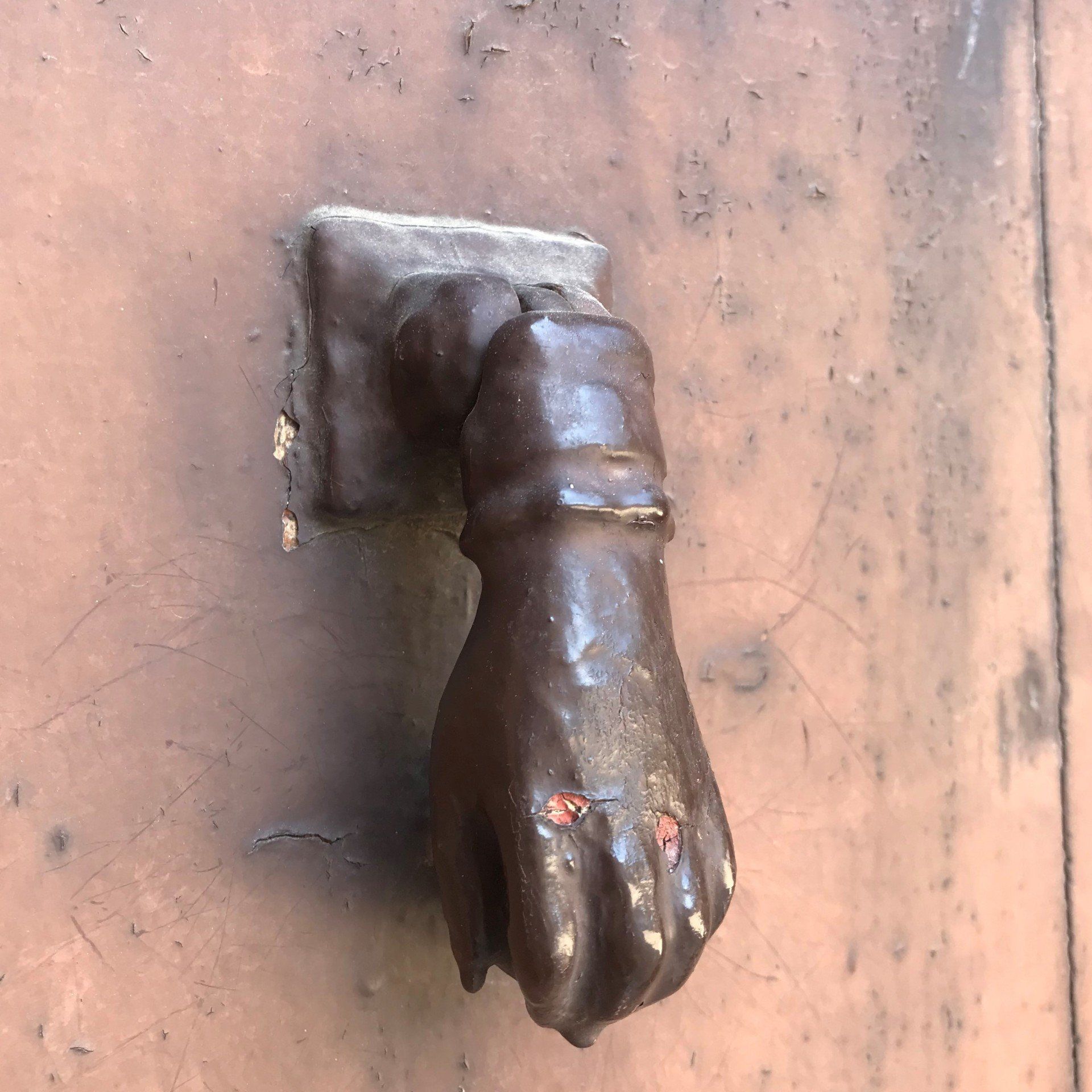 A door knocker in the shape of a hand
