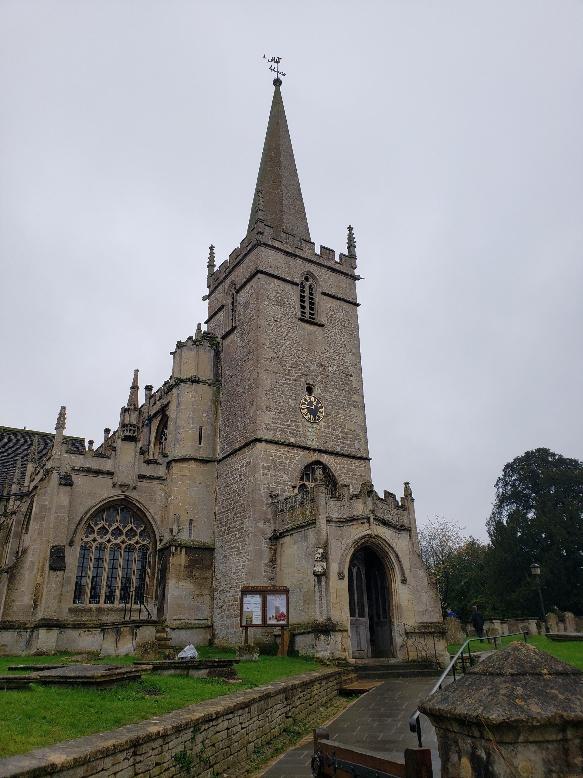 A large stone church with a steeple on a cloudy day.