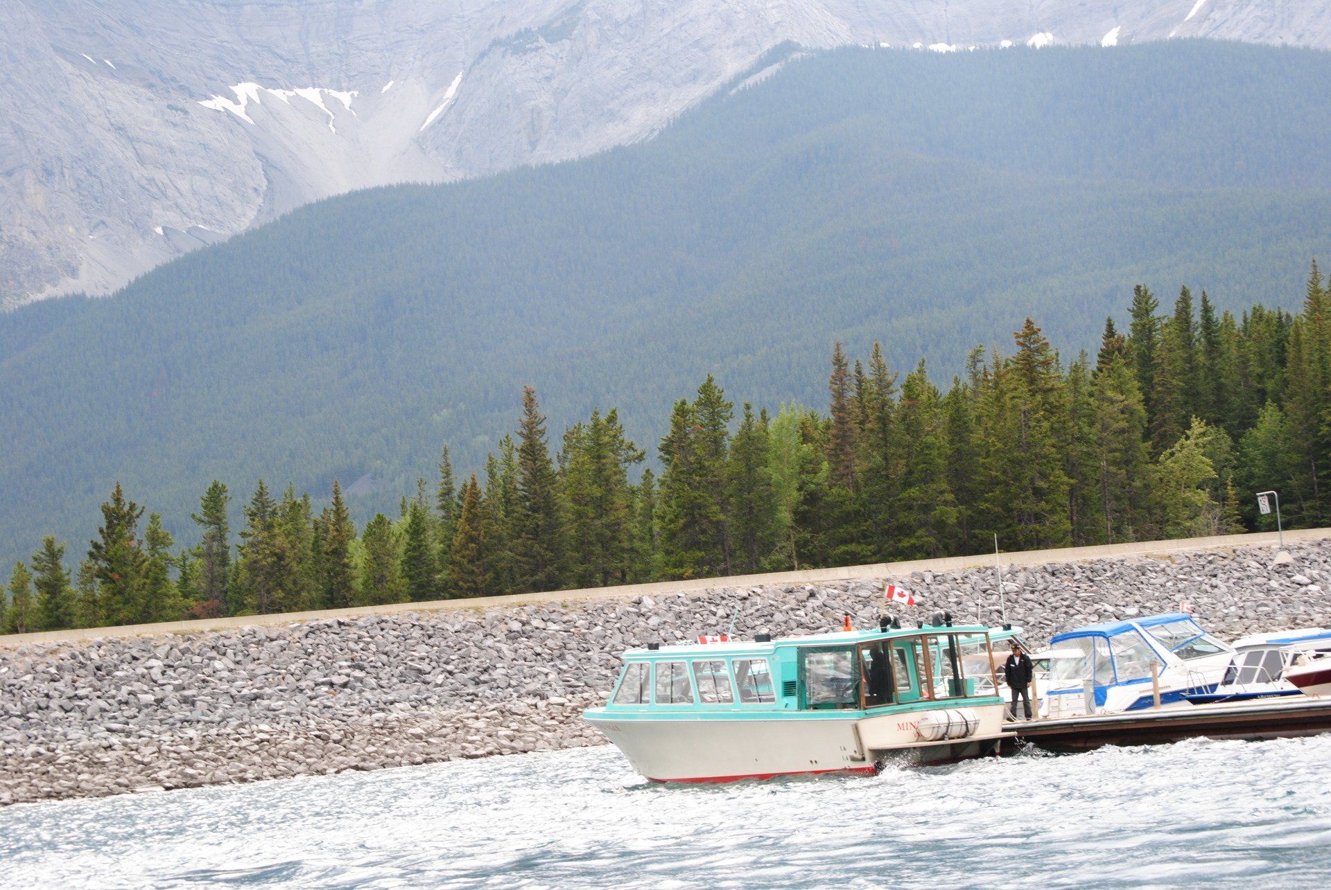 A boat with a canadian flag on the side of it