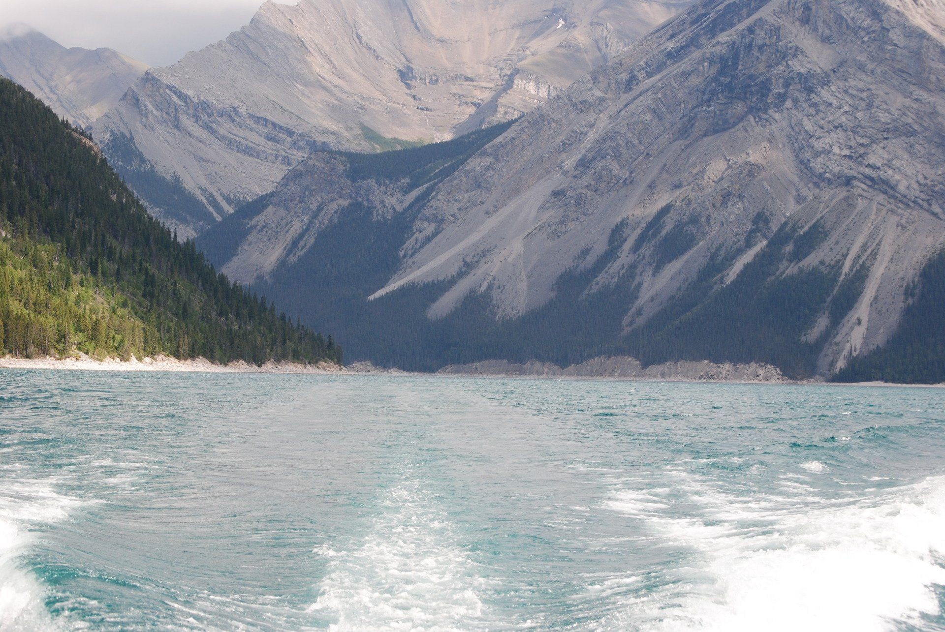 A lake with mountains in the background and a boat in the foreground
