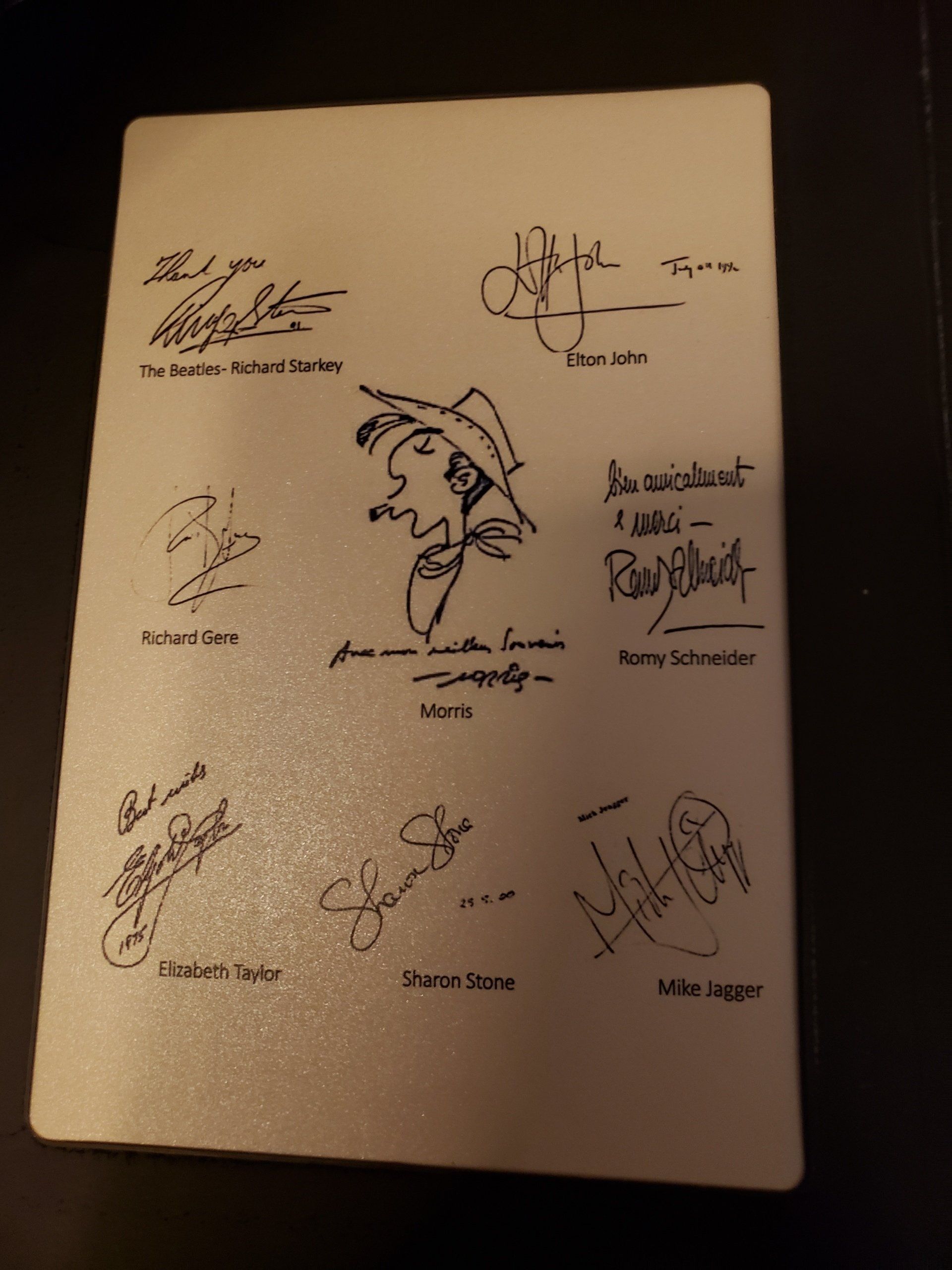 A white piece of paper with many signatures on it
