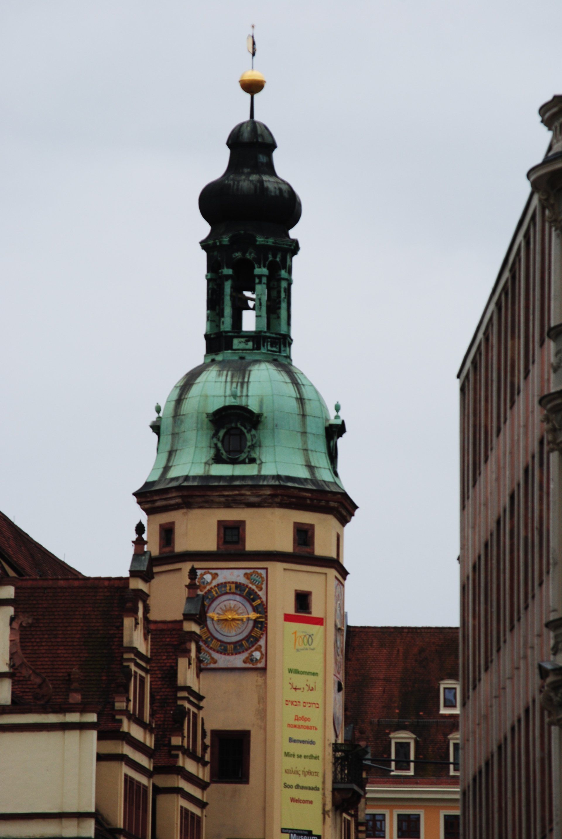 A clock tower with a bell on top of it