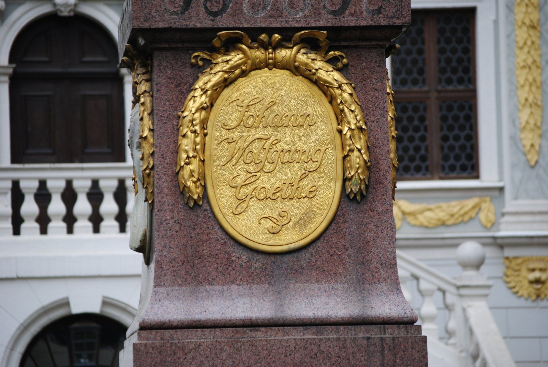 A stone pillar with a gold emblem on it