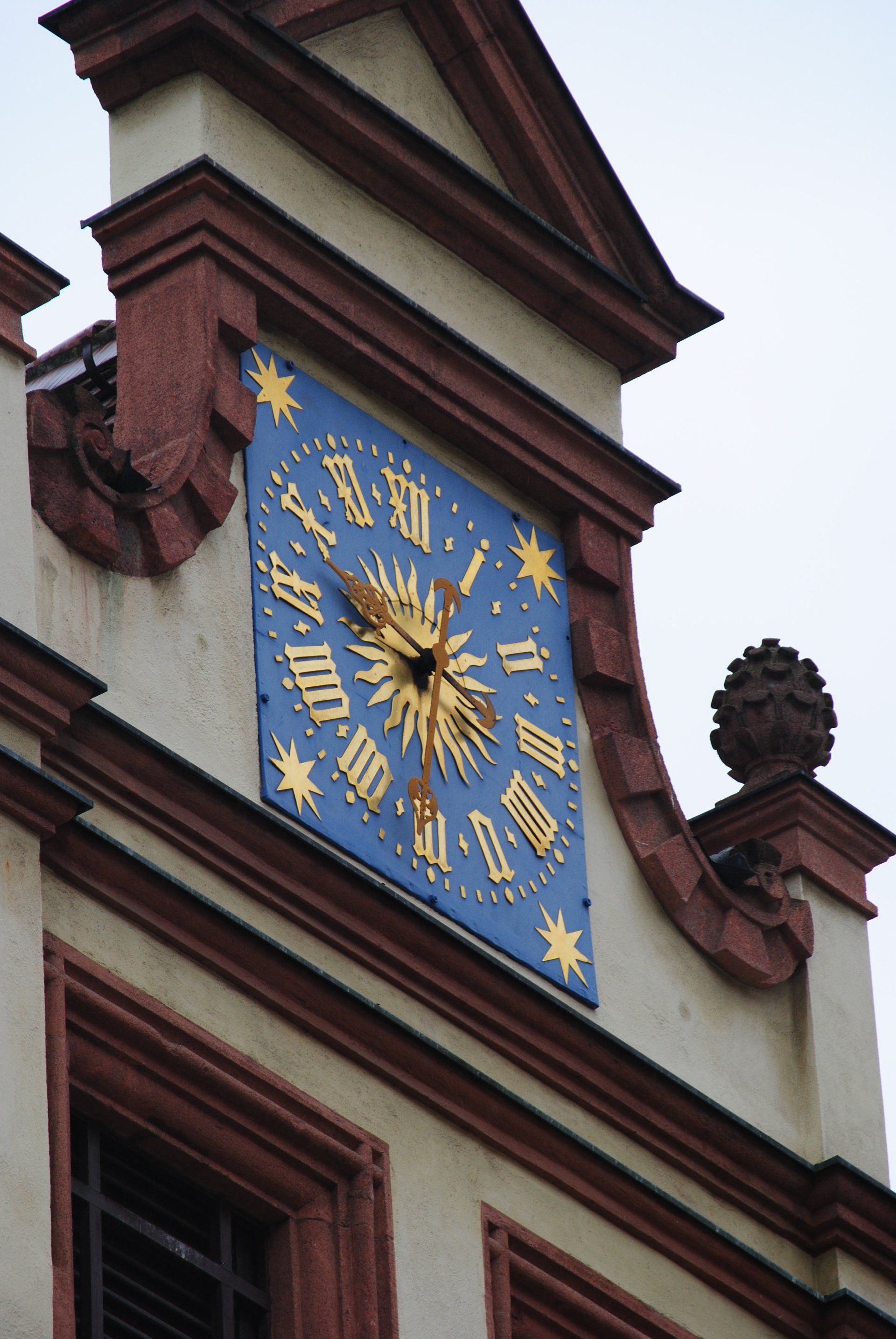 A clock on the side of a building shows the time as 4:20