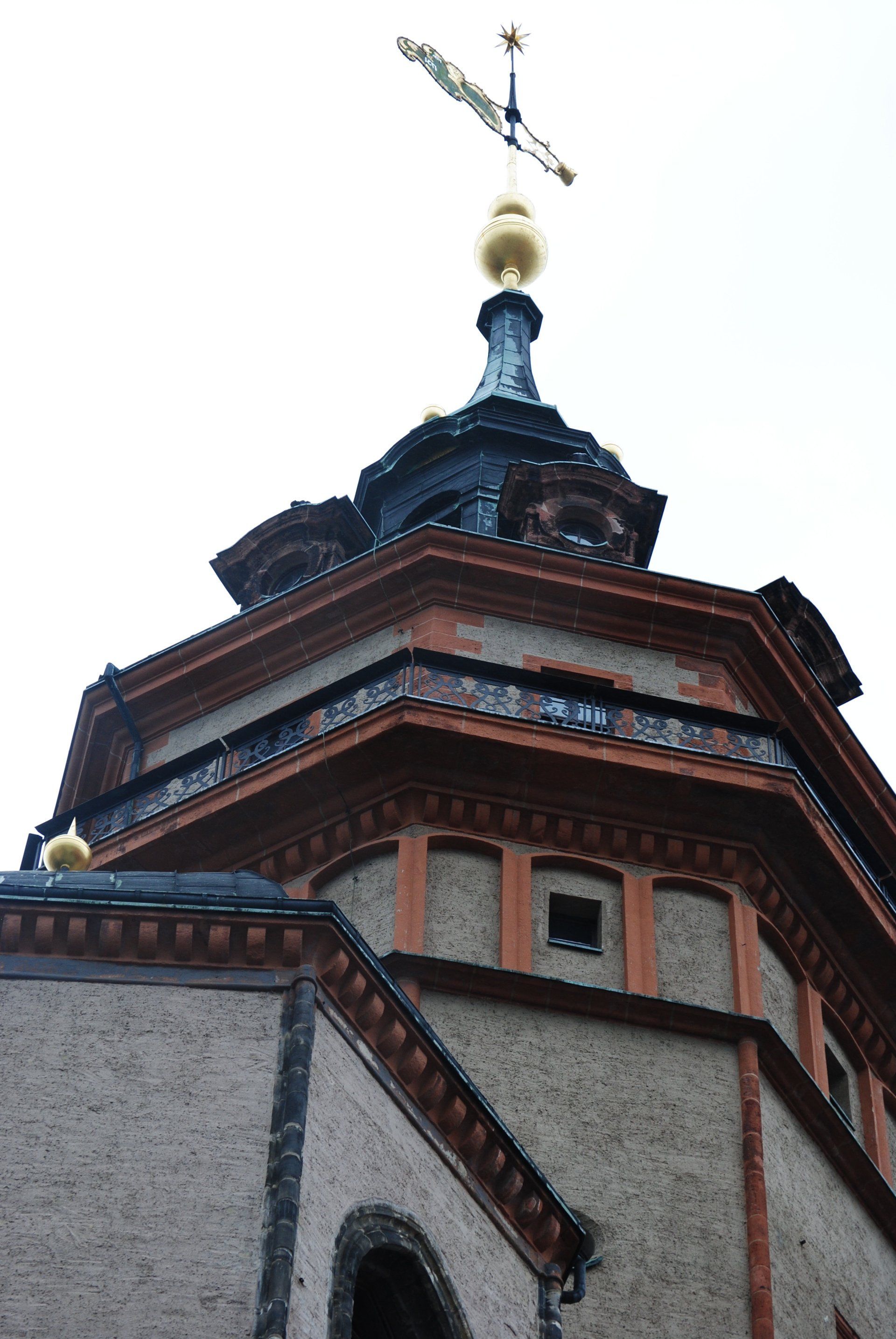 A building with a weather vane on top of it