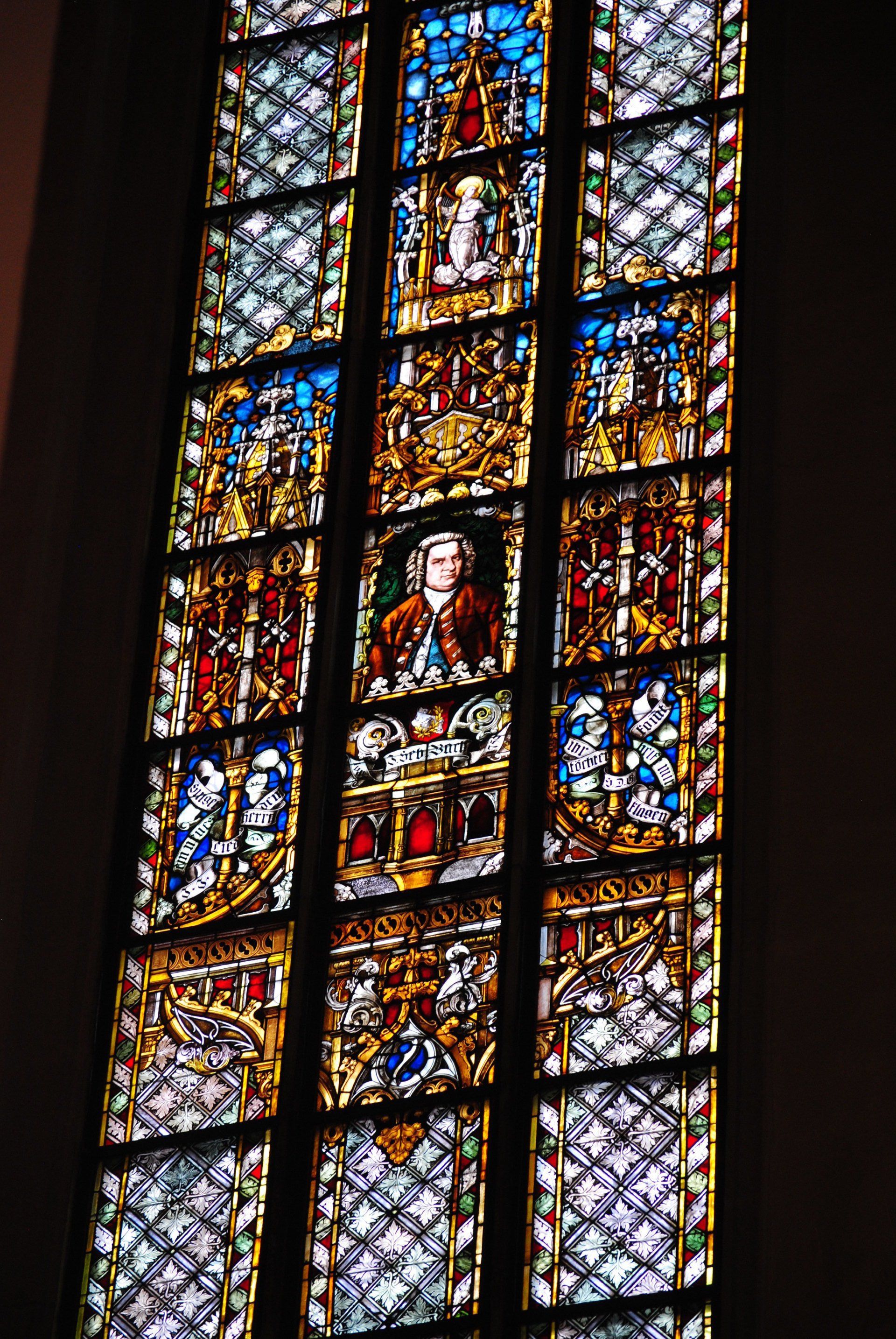 A stained glass window with a picture of a man on it