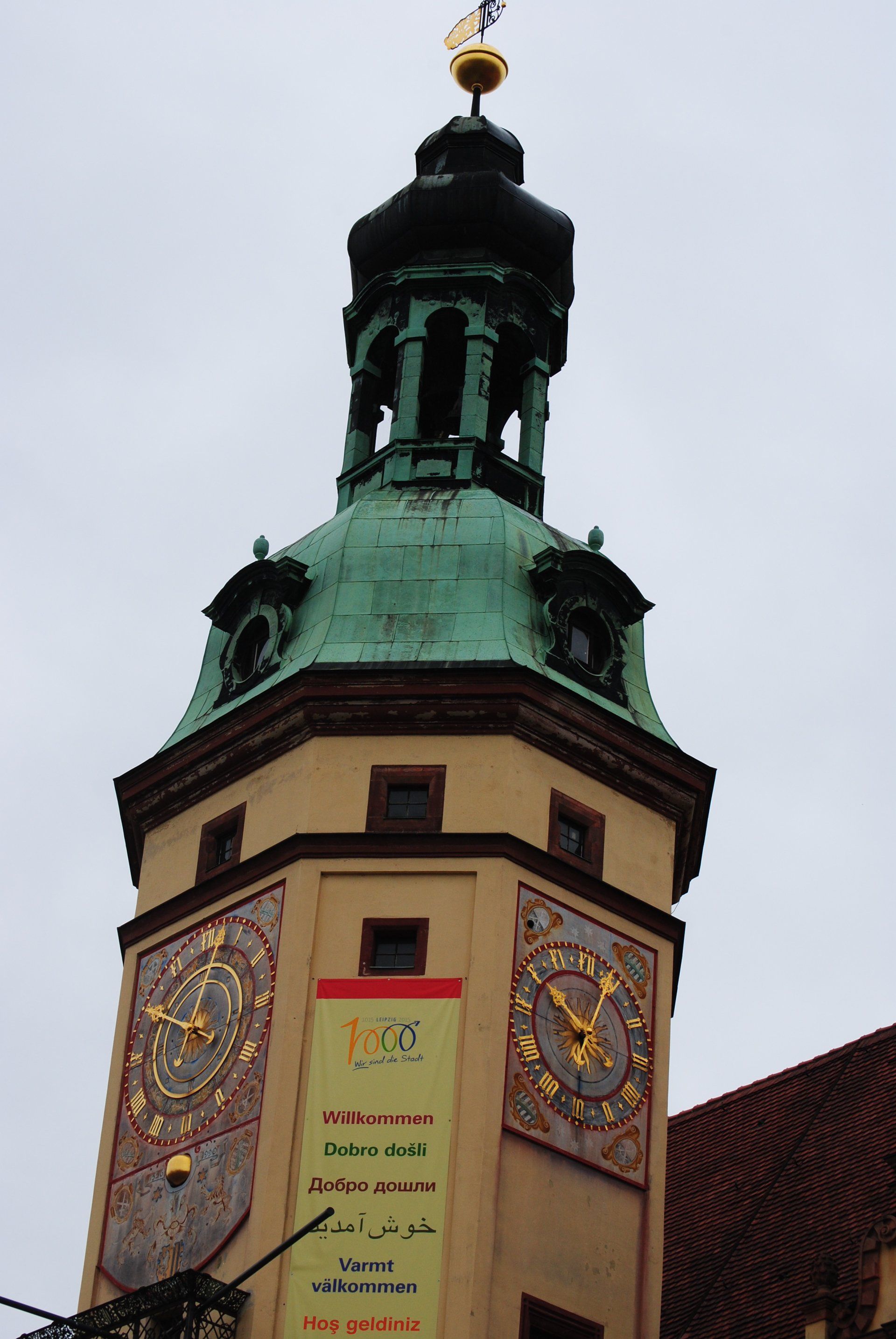 A clock tower with a banner that says jvc on it