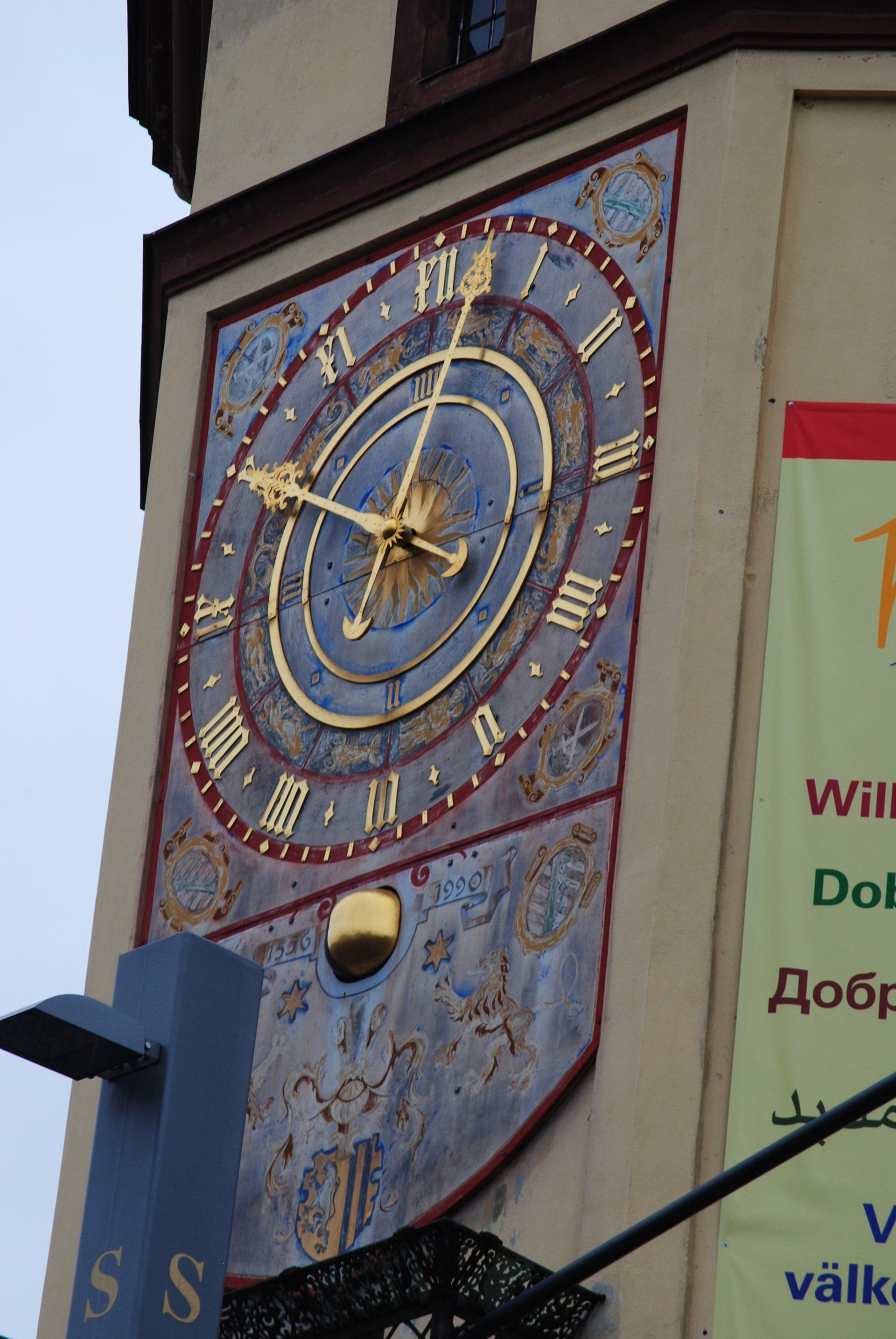 A large clock on the side of a building shows the time as 10:10