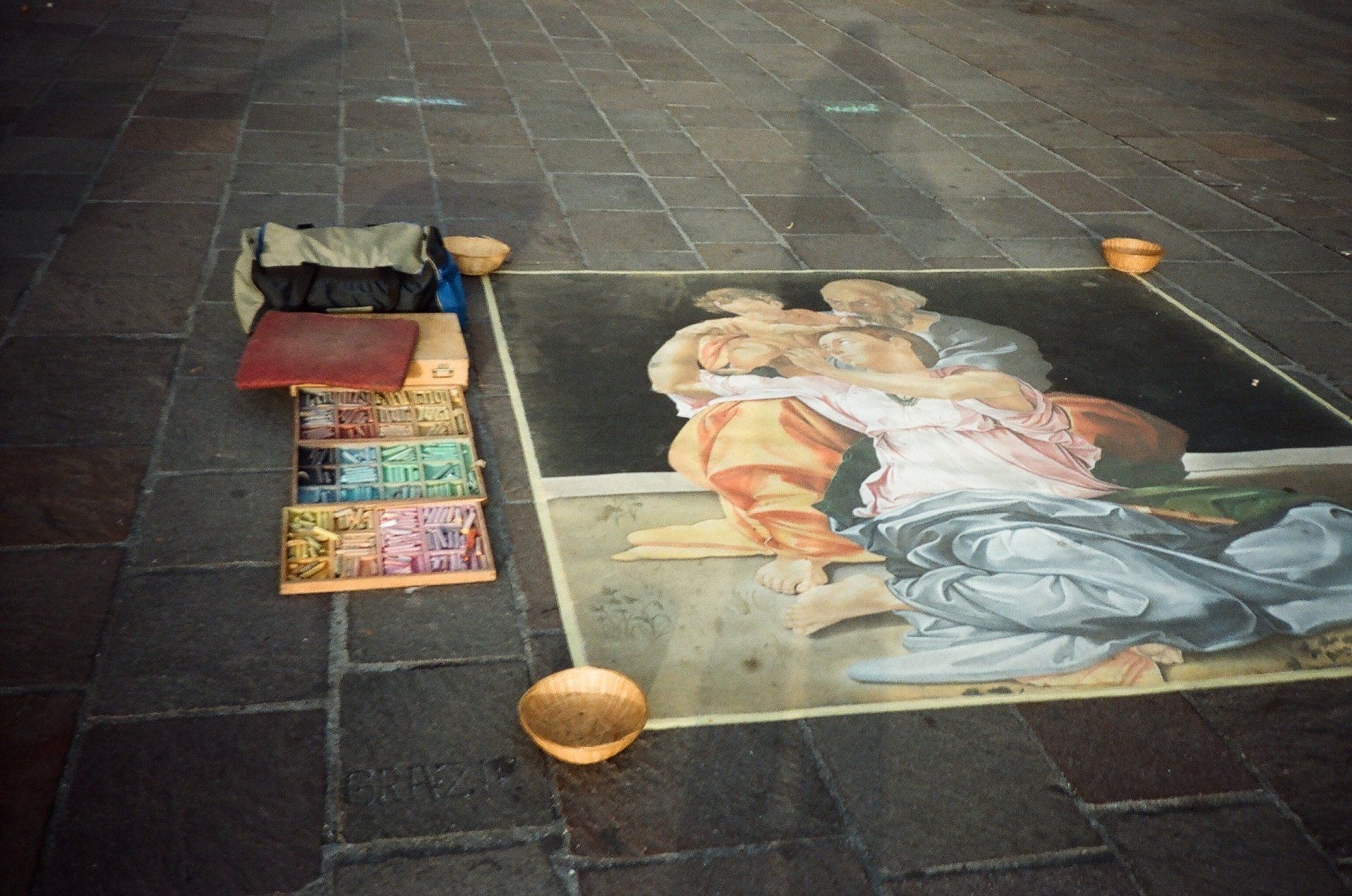 A painting of a man and woman is on the ground