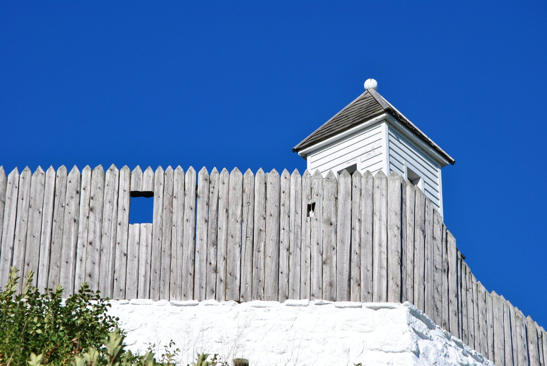 A wooden fence with a tower on top of it