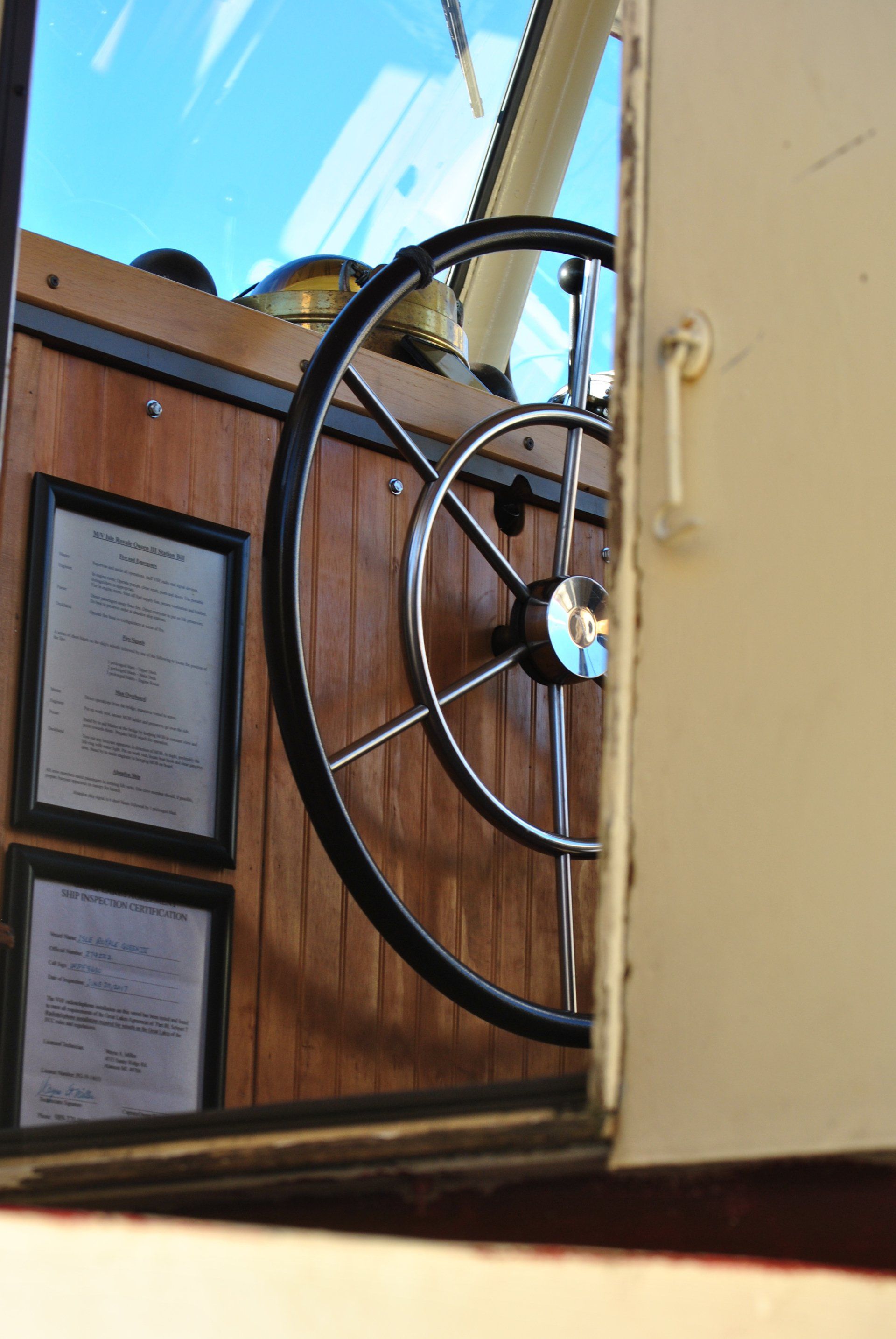 A close up of a steering wheel on a boat