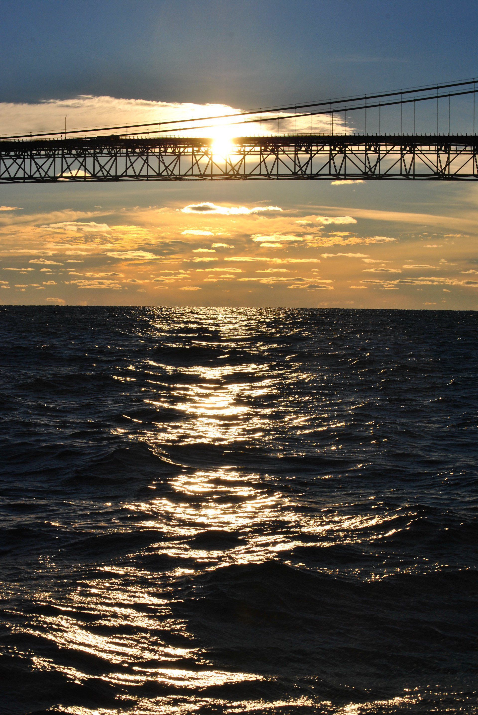 A bridge over a body of water at sunset