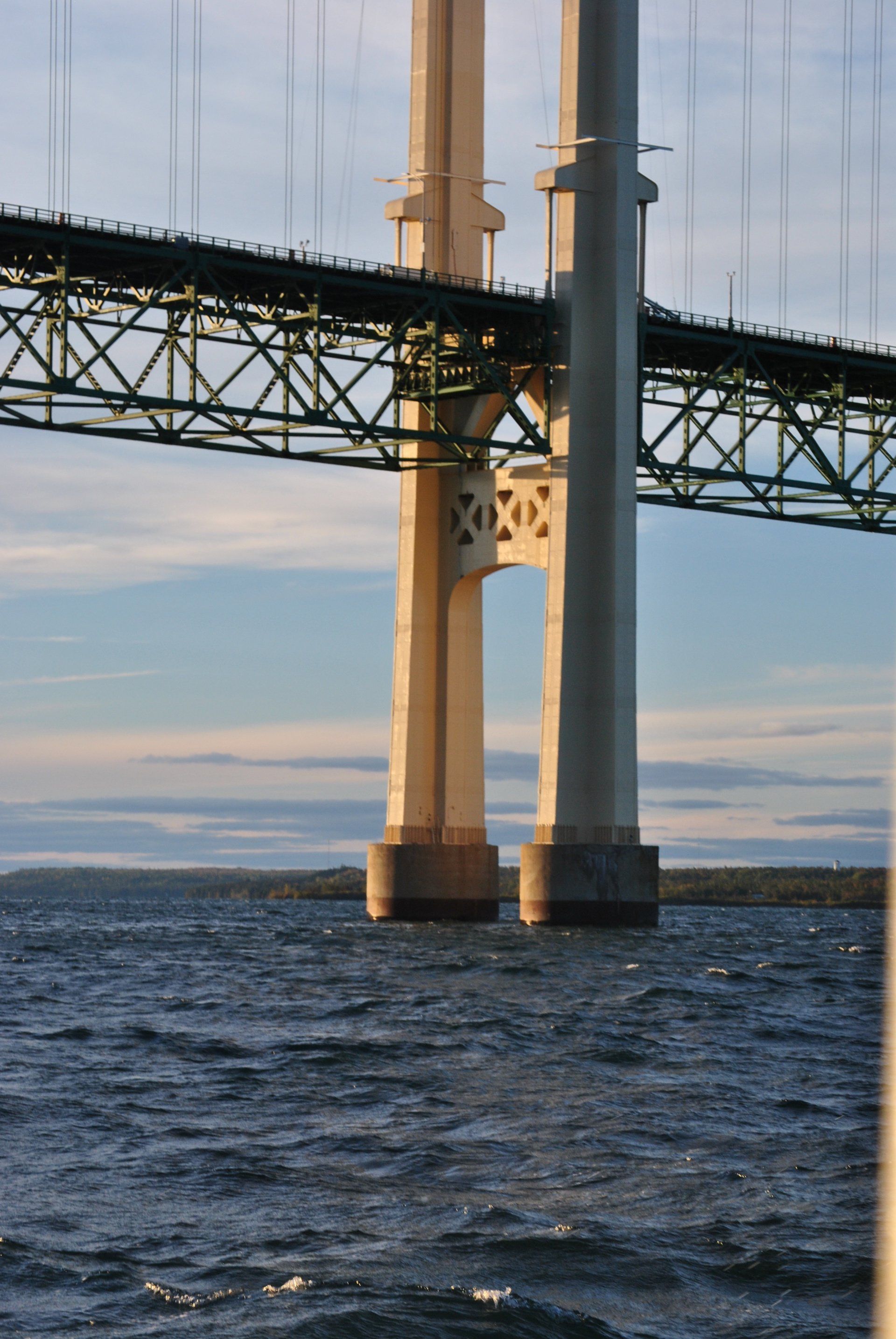 A bridge over a body of water with a blue sky in the background