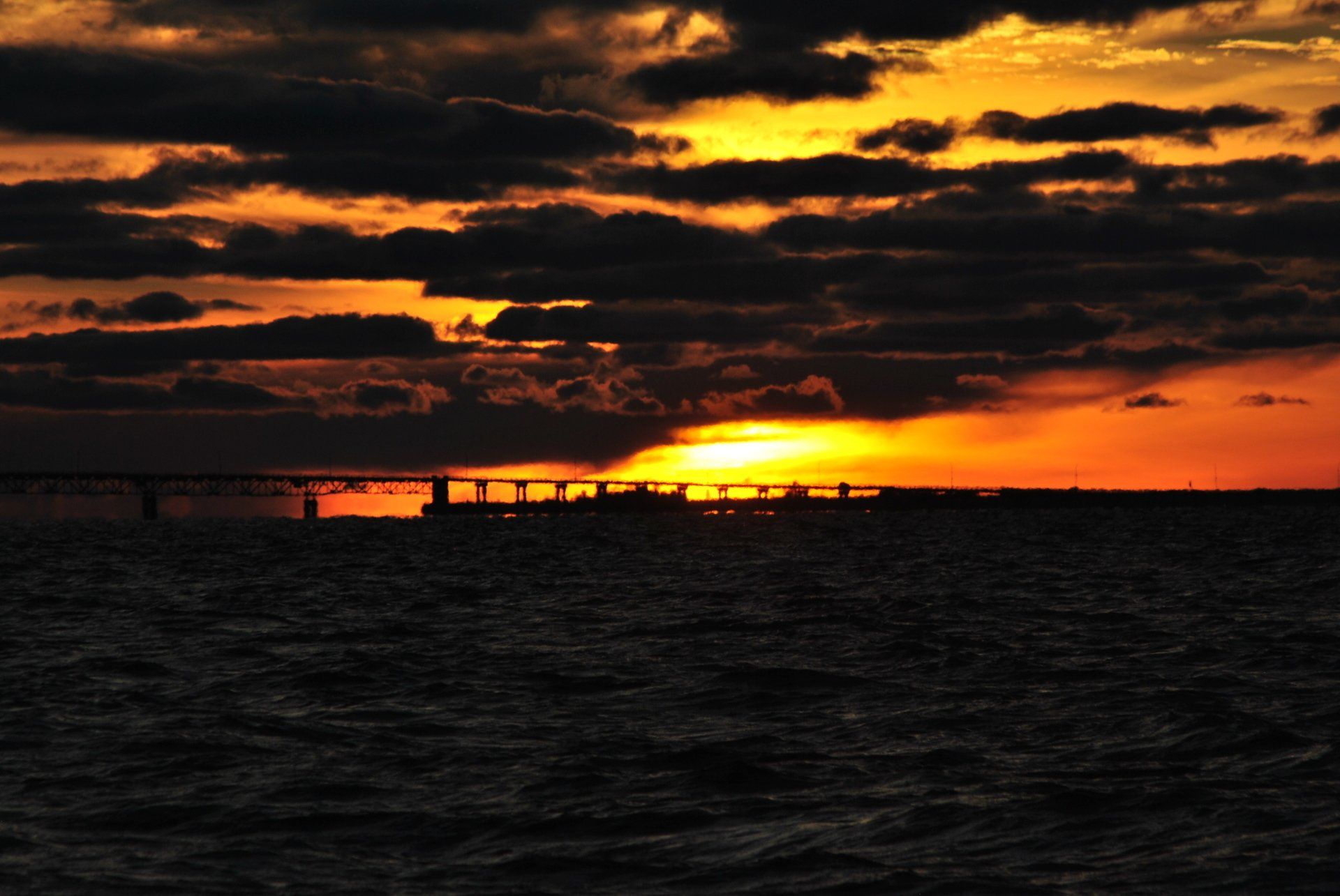 A bridge over a body of water at sunset