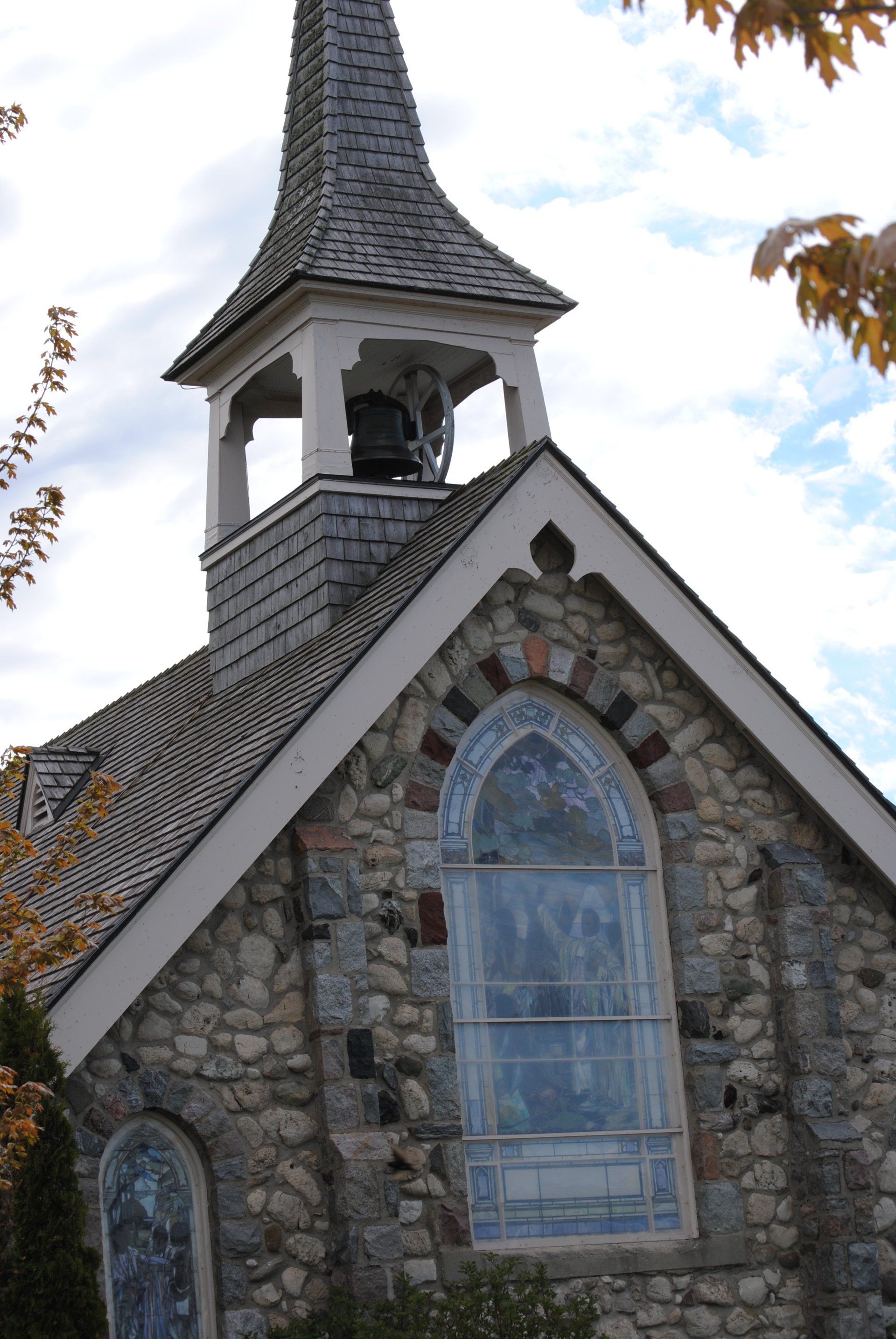 A church with a bell tower and a stained glass window