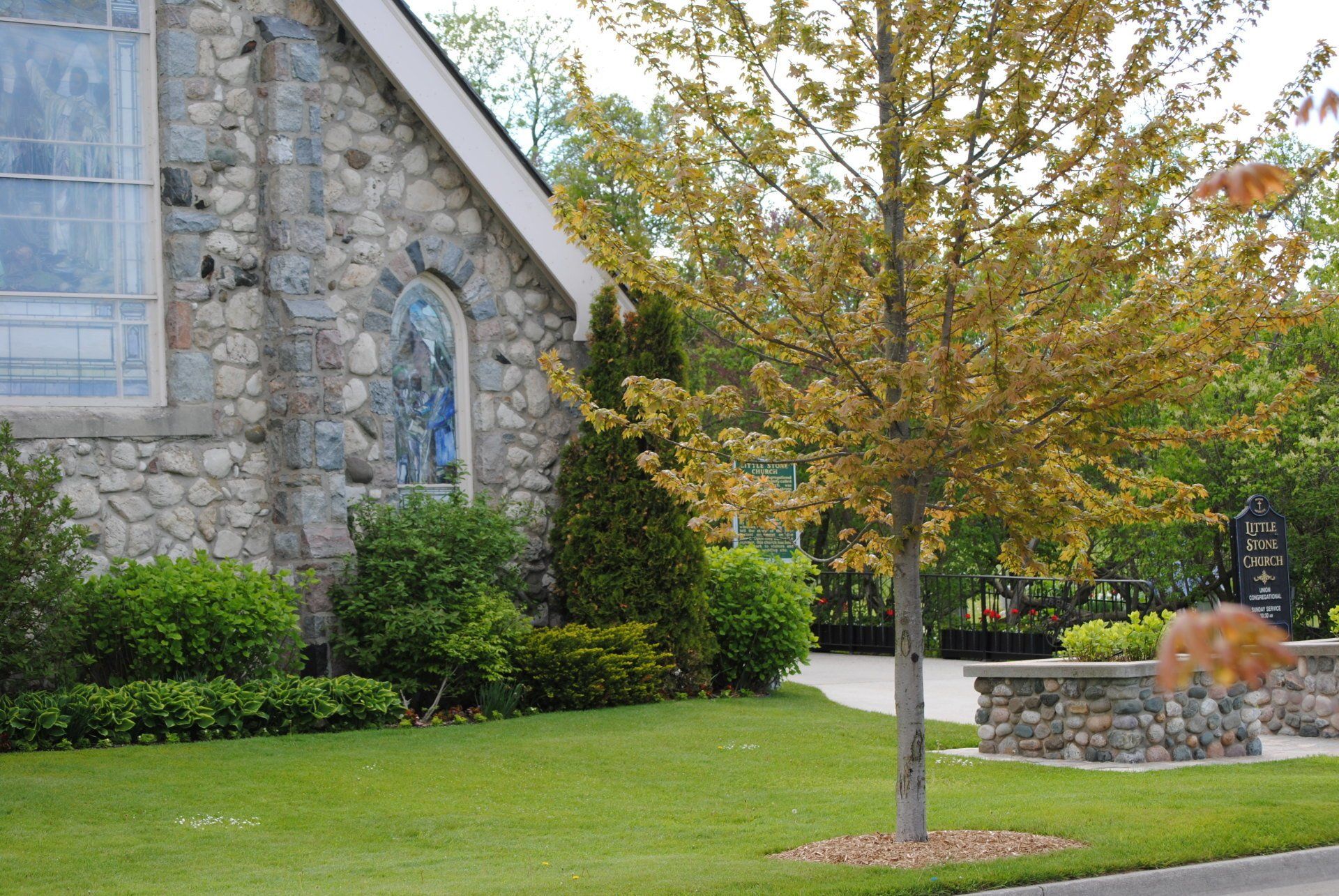 A stone building with a tree in front of it