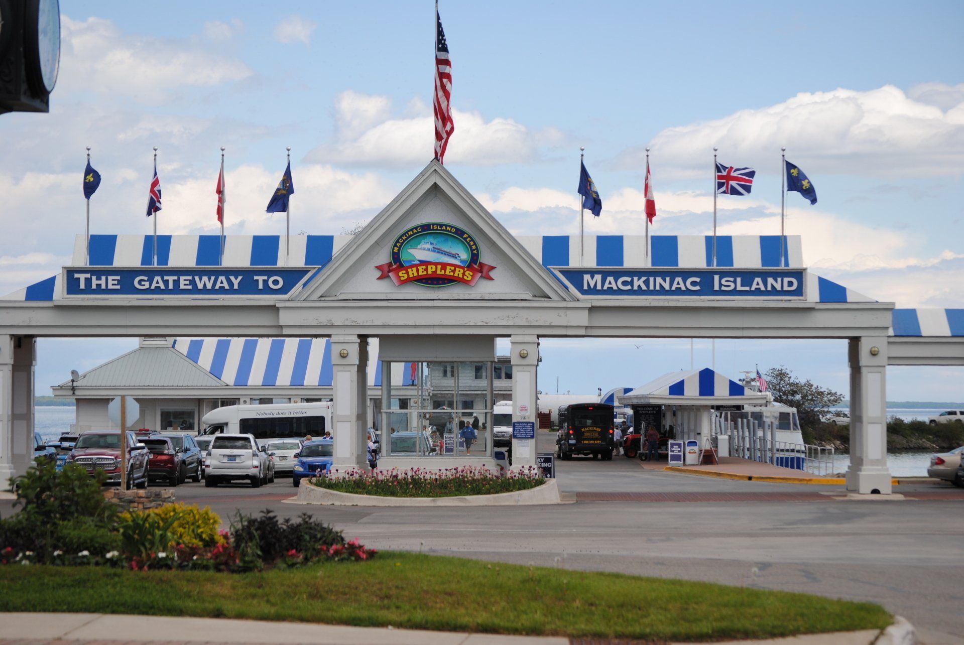 The gateway to maconac island is shown with cars parked in front of it
