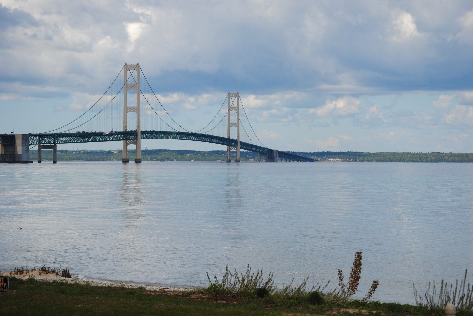A bridge over a body of water with a blue sky in the background