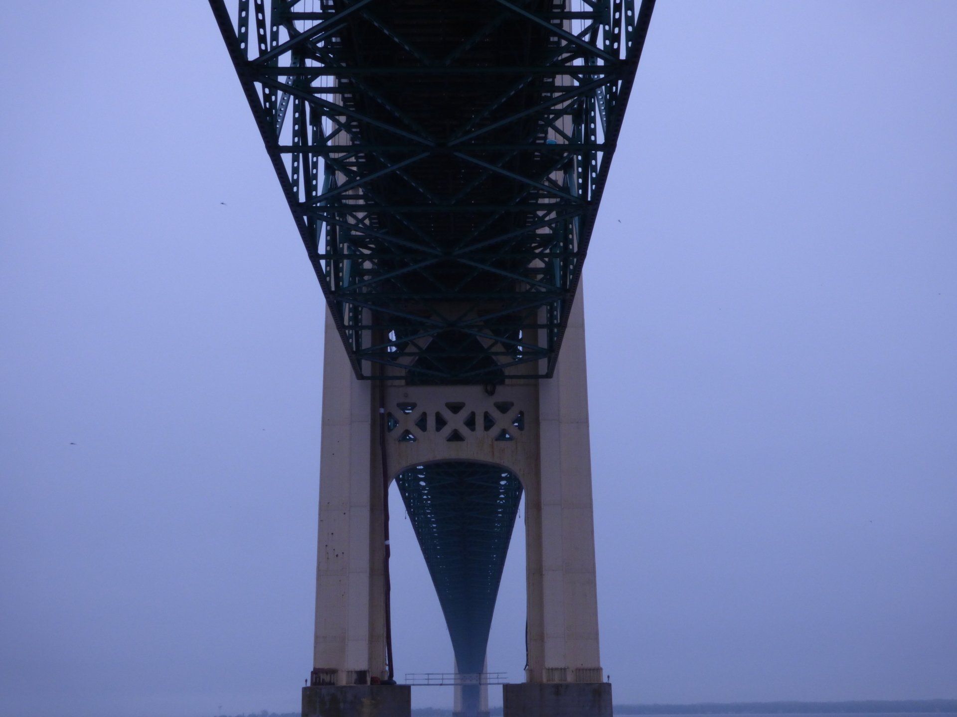 A bridge over a body of water with a blue sky in the background