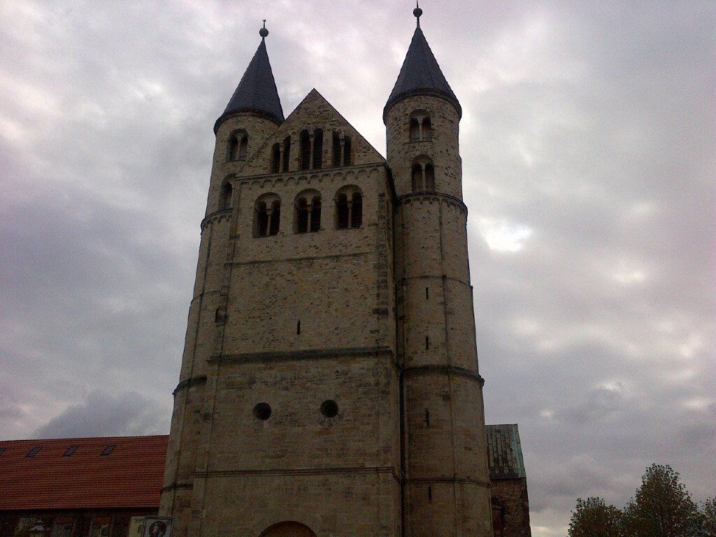 A very tall building with two towers on top of it