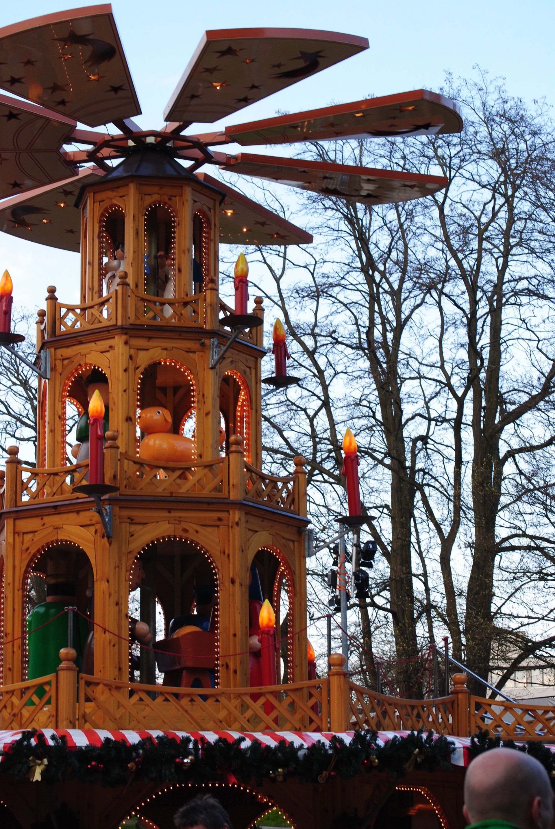 A wooden pyramid with candles on top of it
