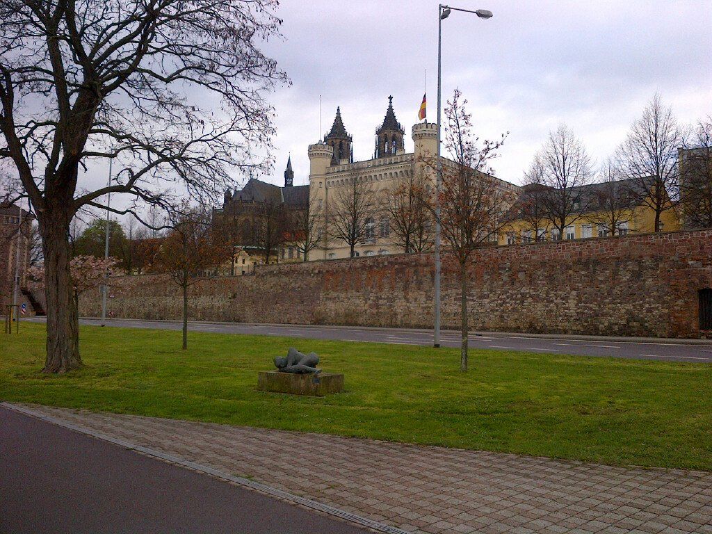 A castle is visible in the distance behind a park