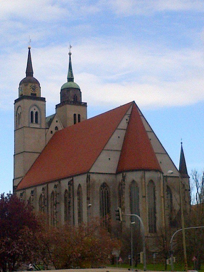 A large church with a red roof and two towers