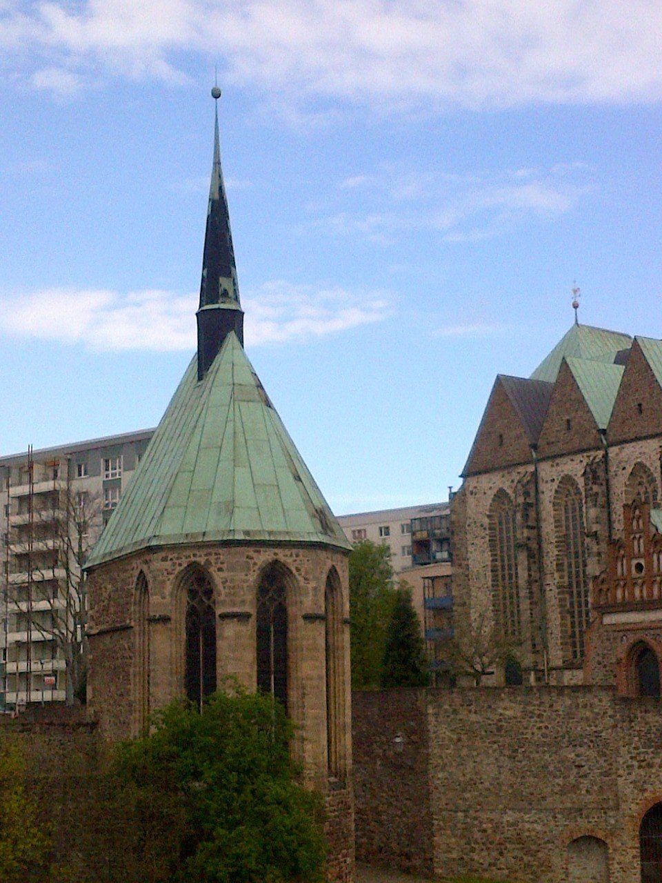 A church with a green roof and a steeple