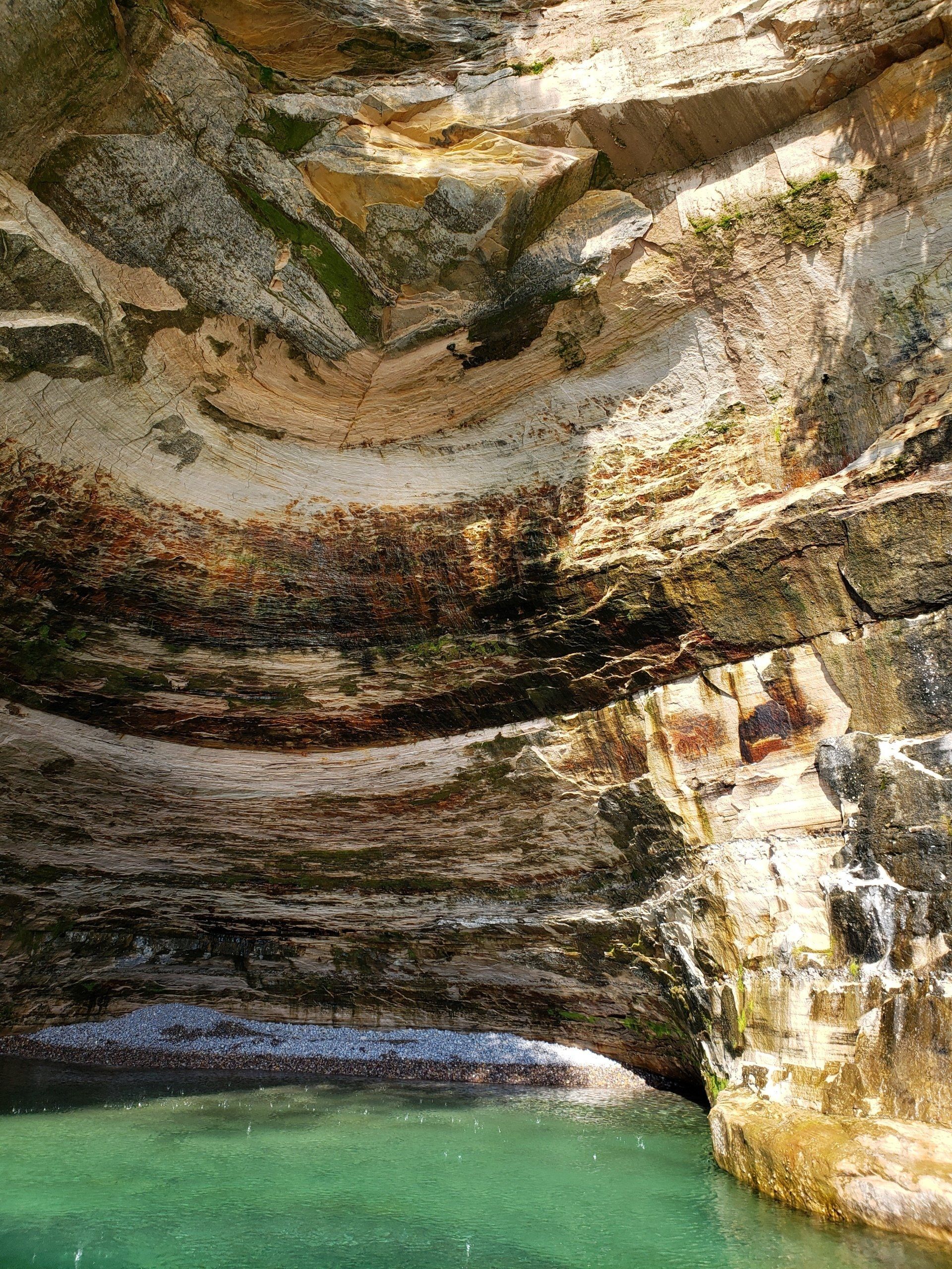 There is a pool of water in the middle of a rocky area.