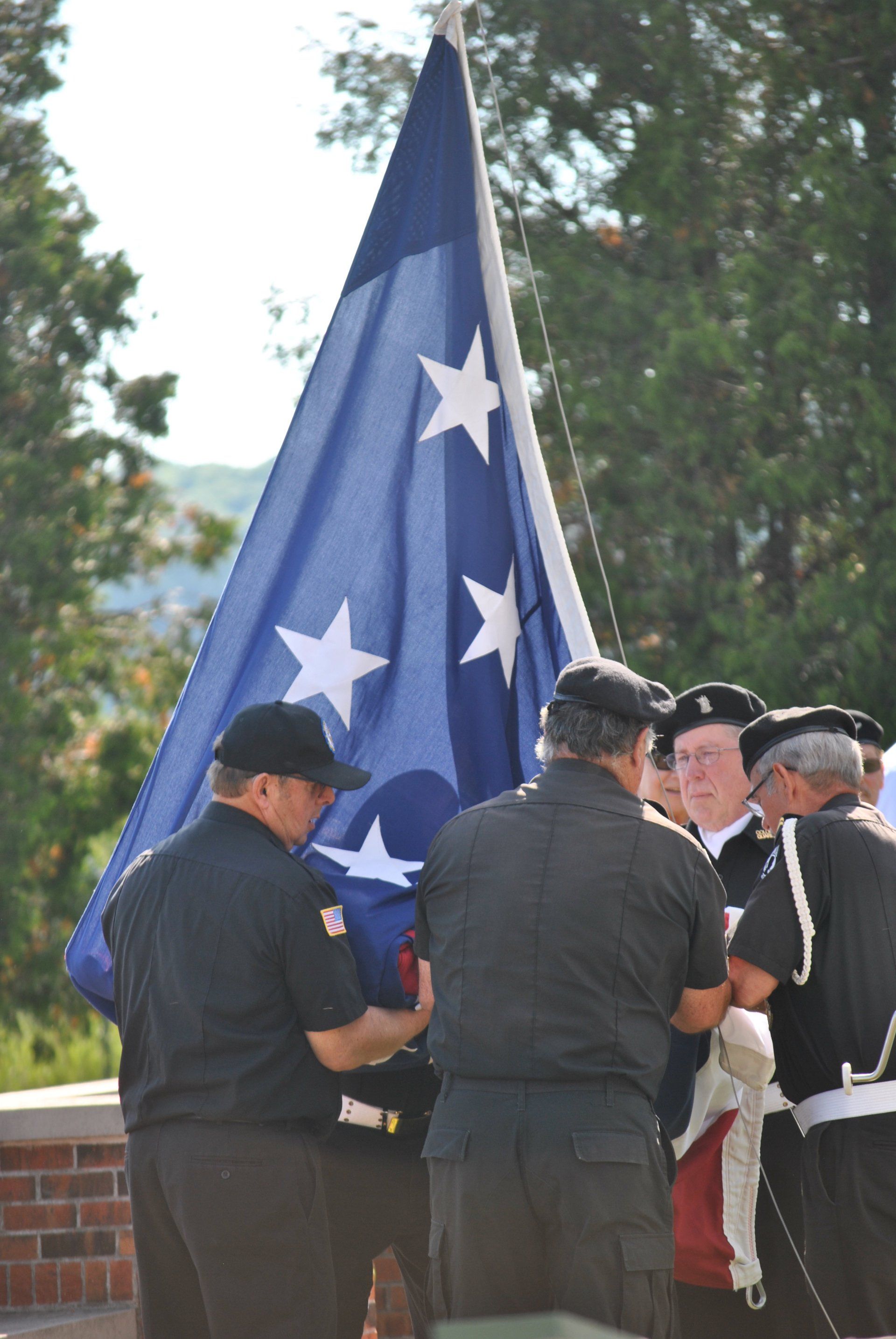A group of men holding an american flag with stars on it