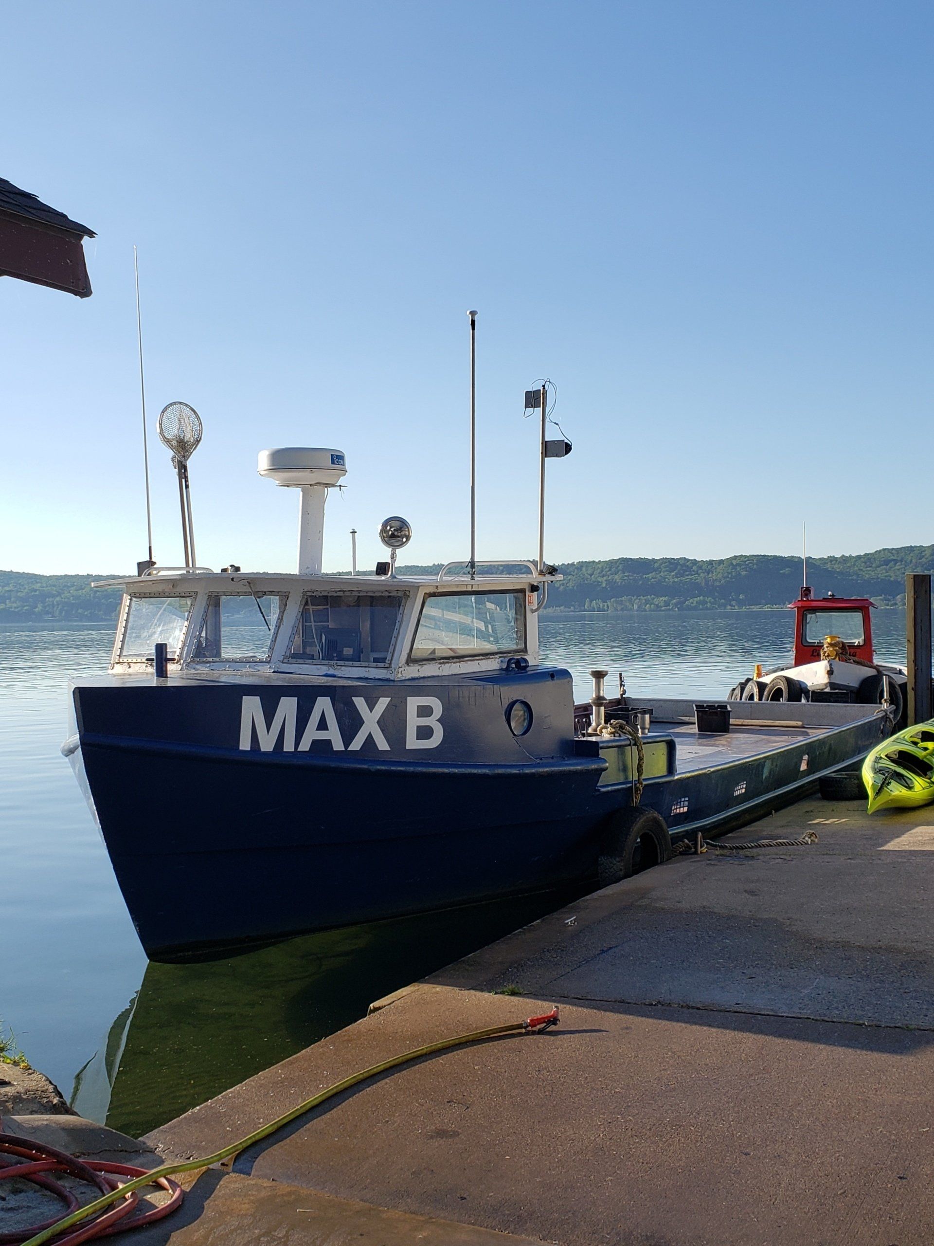 A boat named max b is docked at a dock