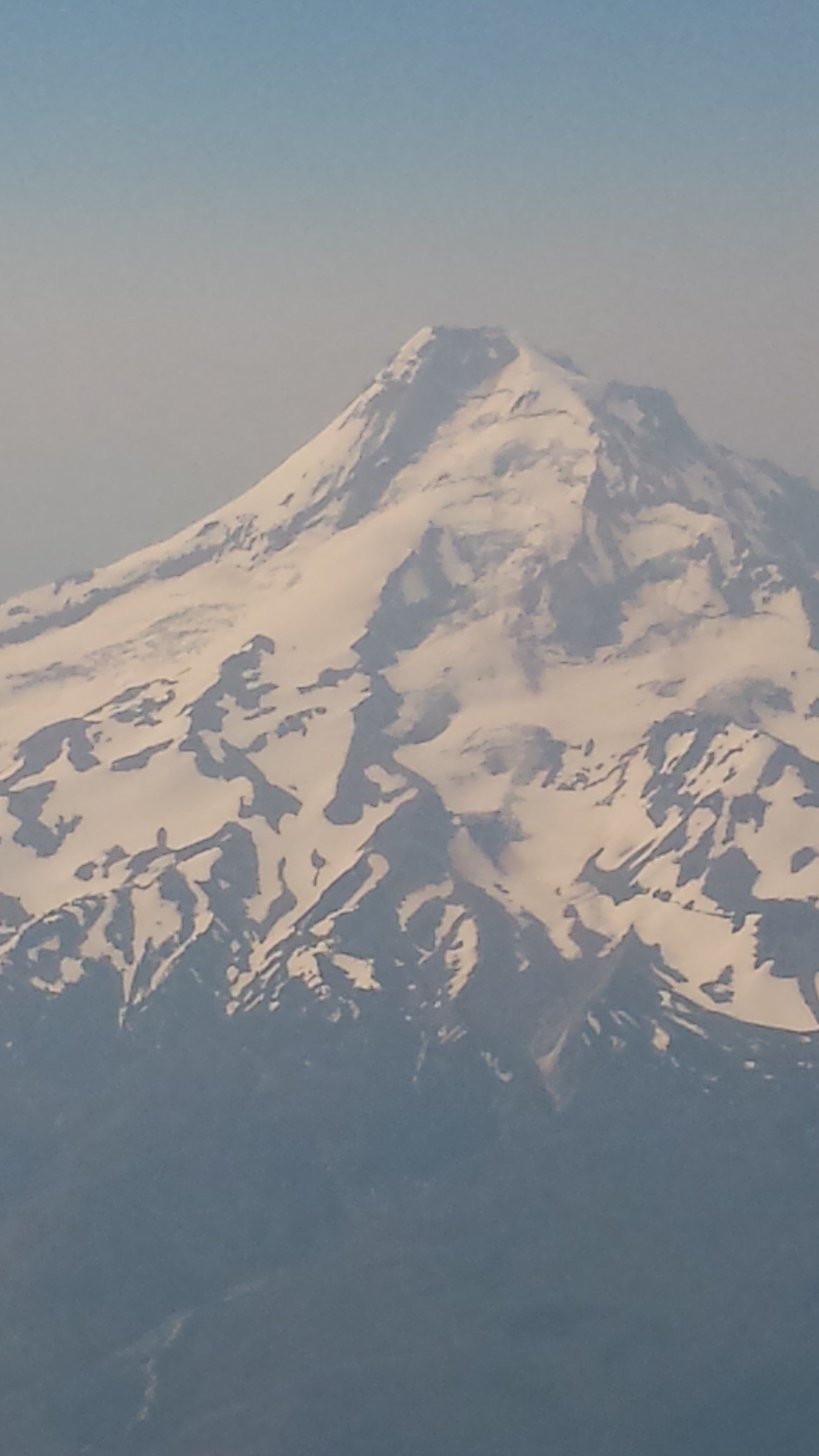 A snowy mountain with a blue sky in the background