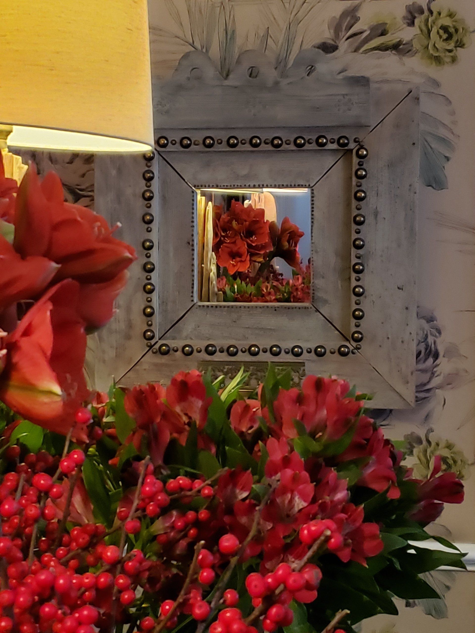 A picture frame with a picture of red flowers in it