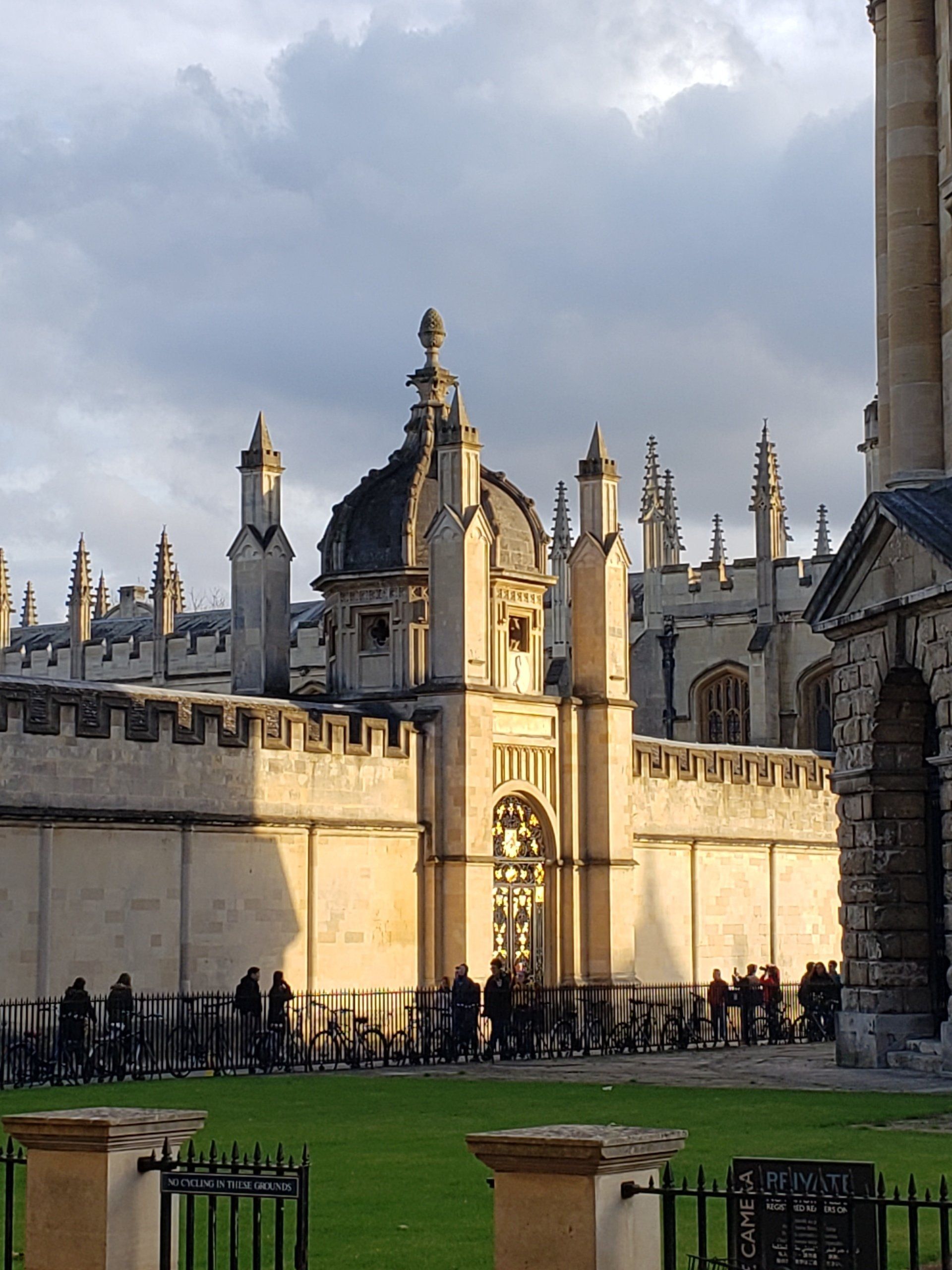 A group of people are standing in front of a large building