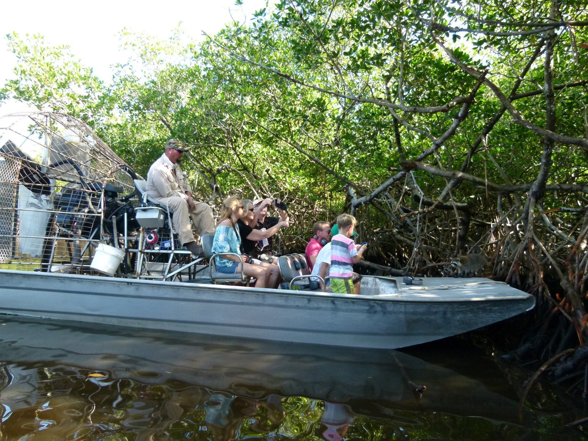 A group of people are sitting on a boat in the water.