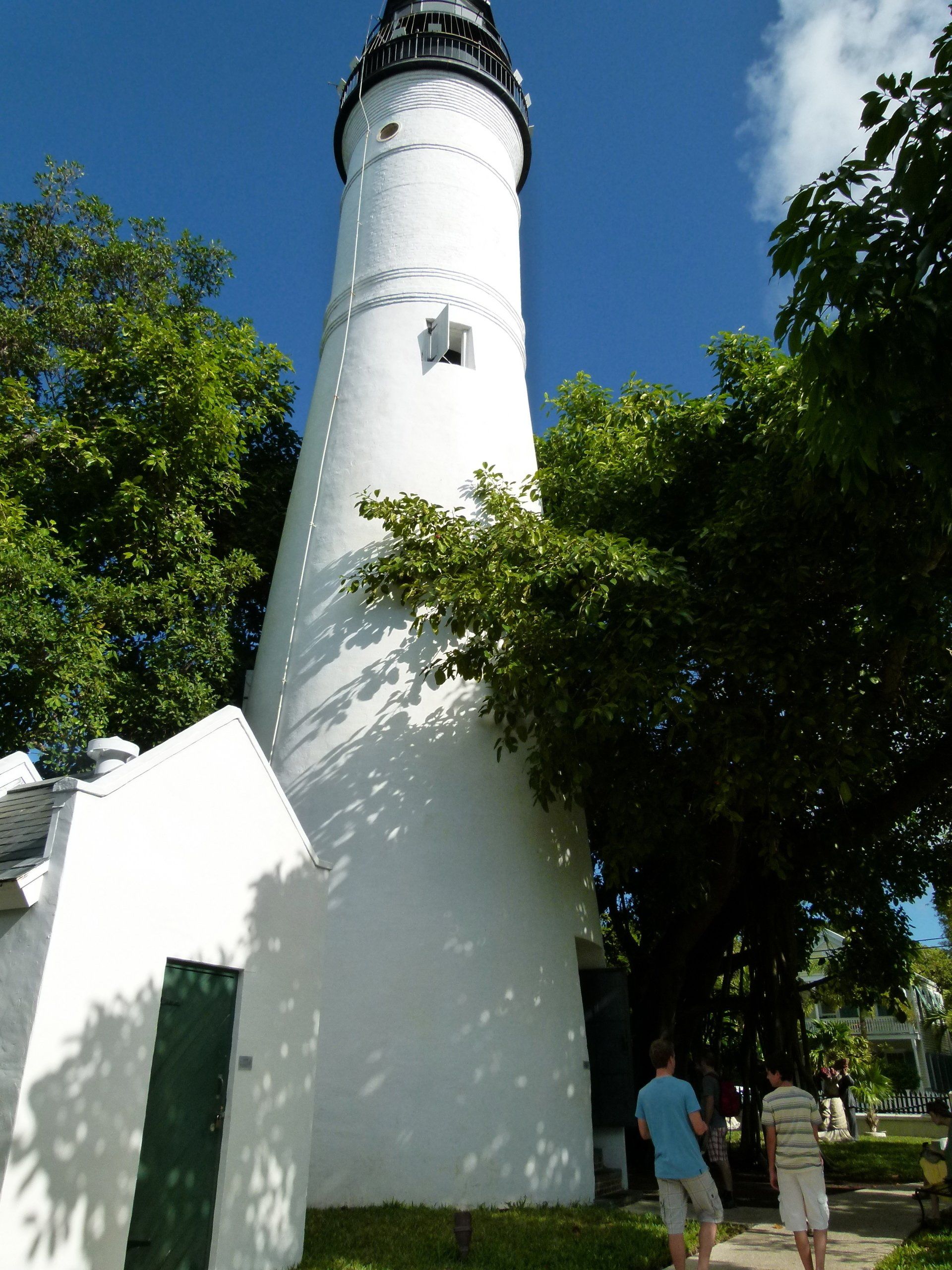 A white lighthouse with a star on the top of it
