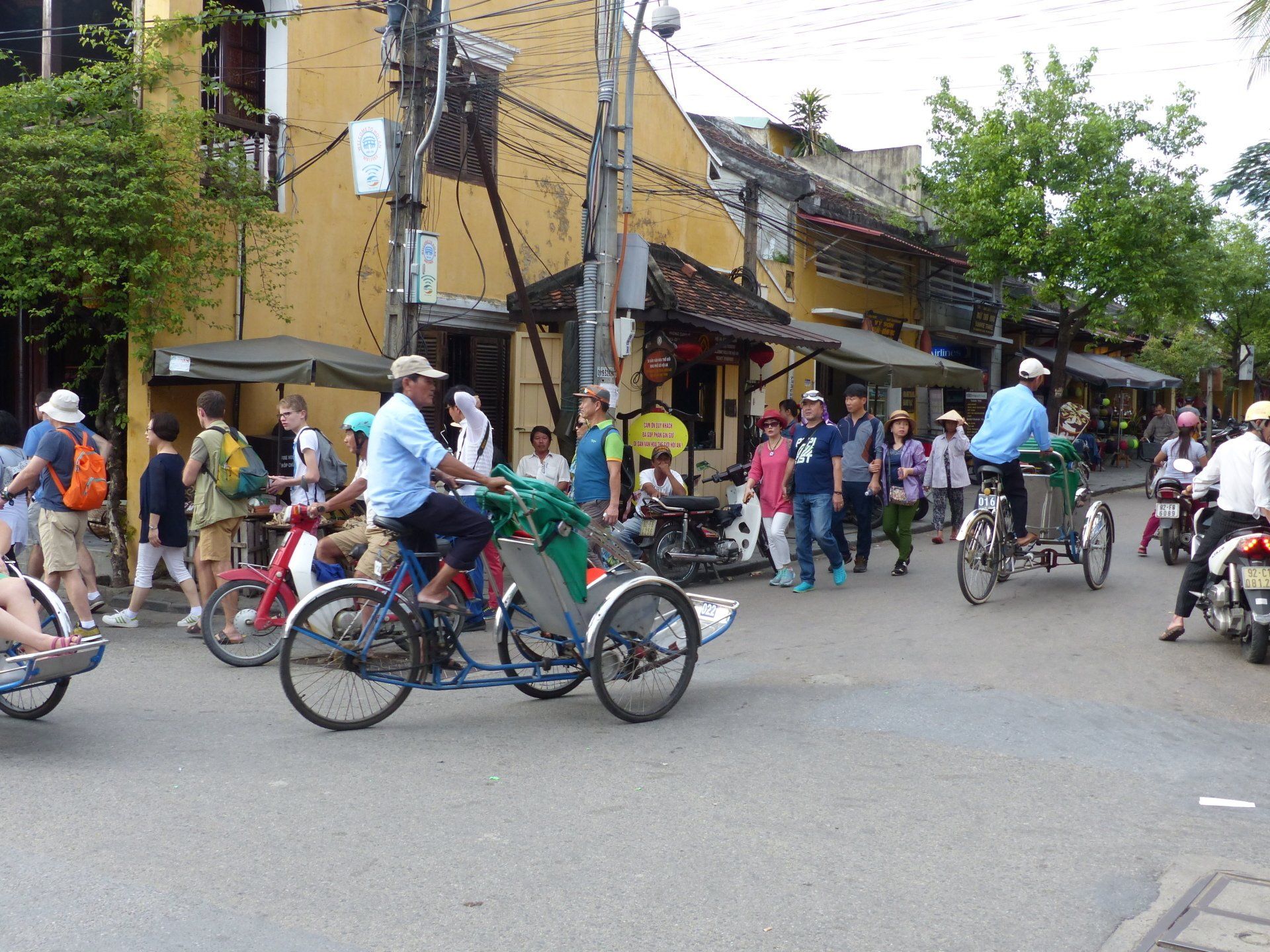 A group of people are riding bicycles down a street