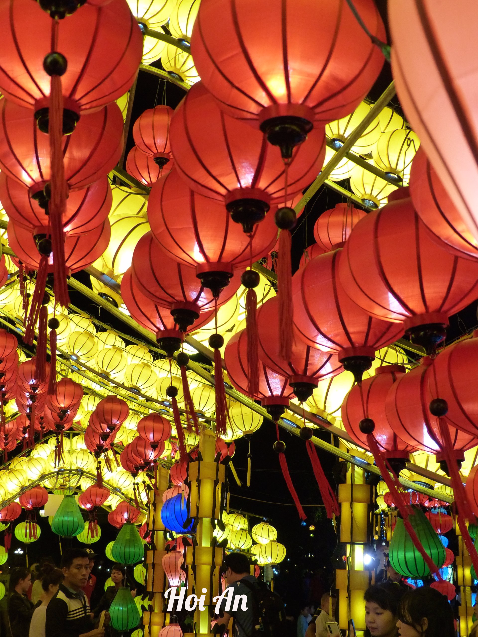 A bunch of red lanterns are hanging from the ceiling