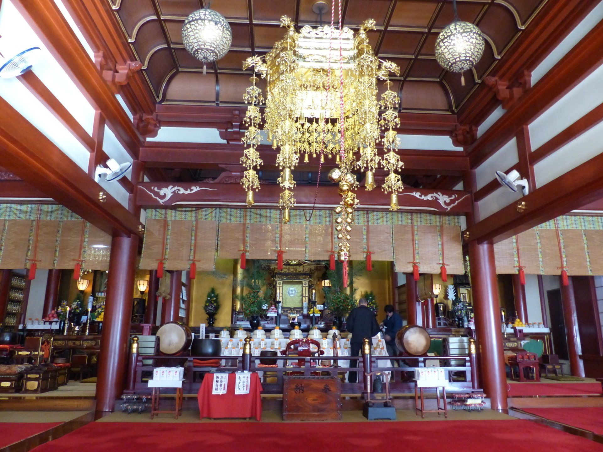 The inside of a temple with a chandelier hanging from the ceiling