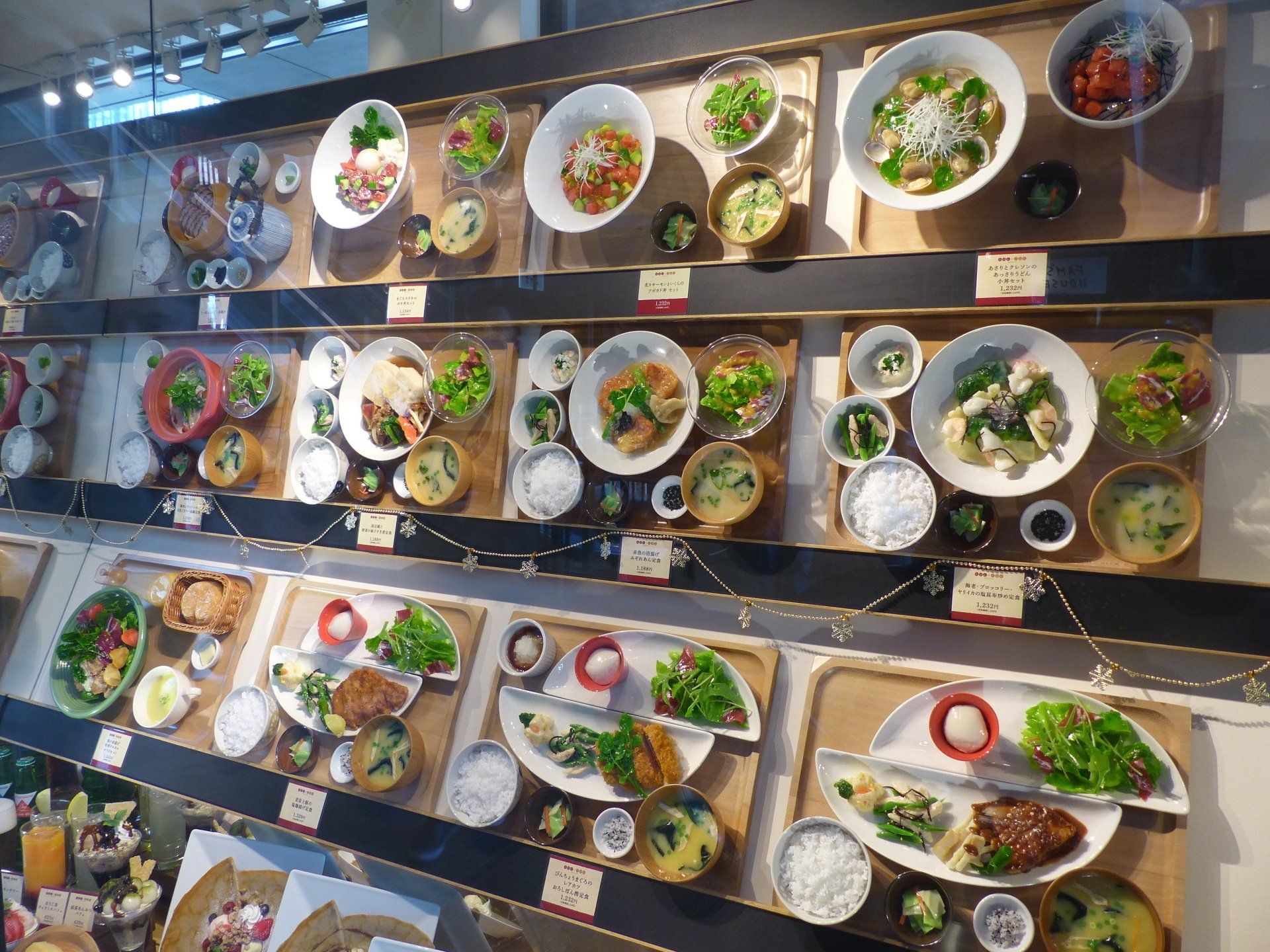 A display case filled with plates and bowls of food.