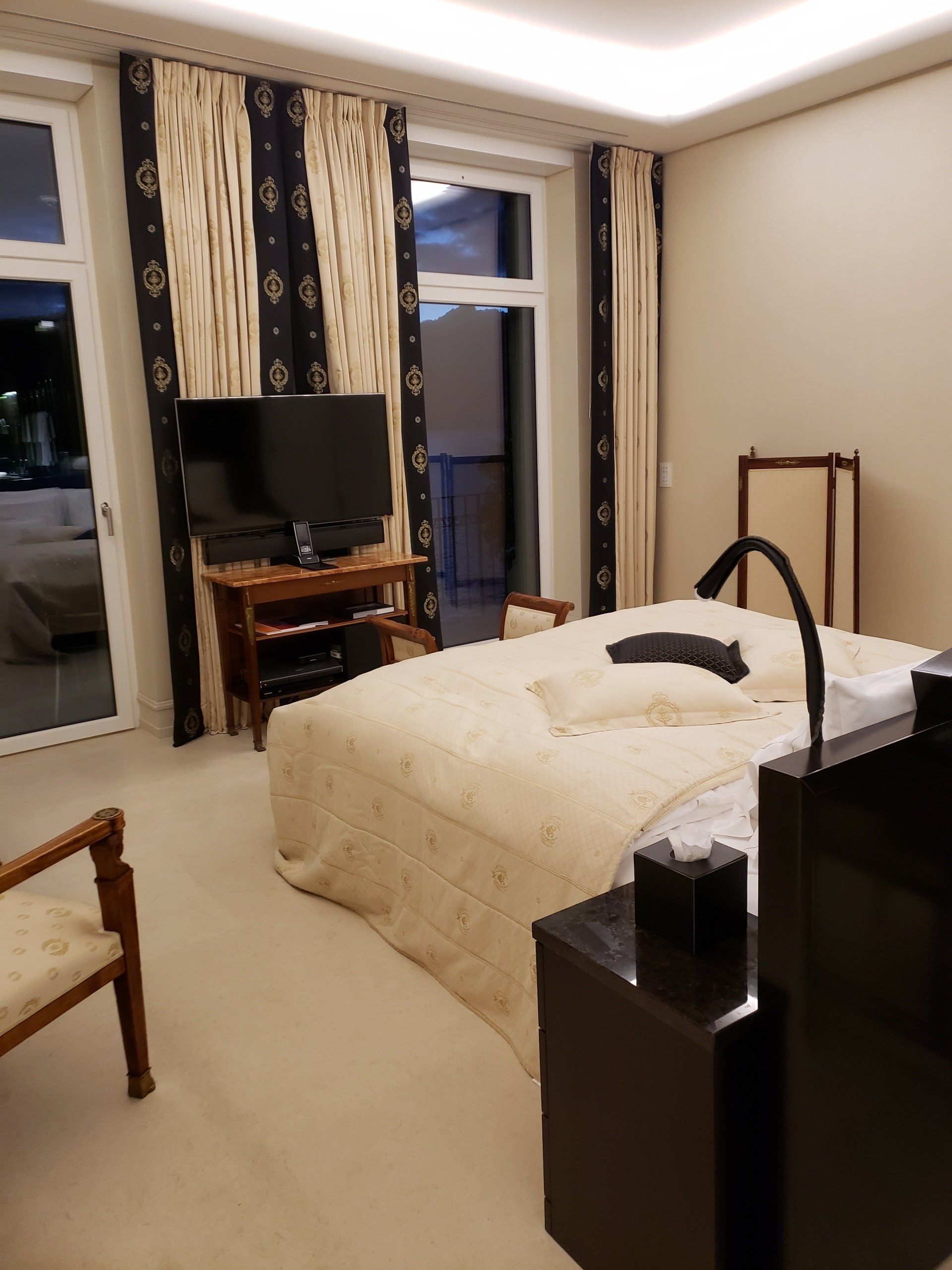 A bedroom with a large bed and a flat screen tv