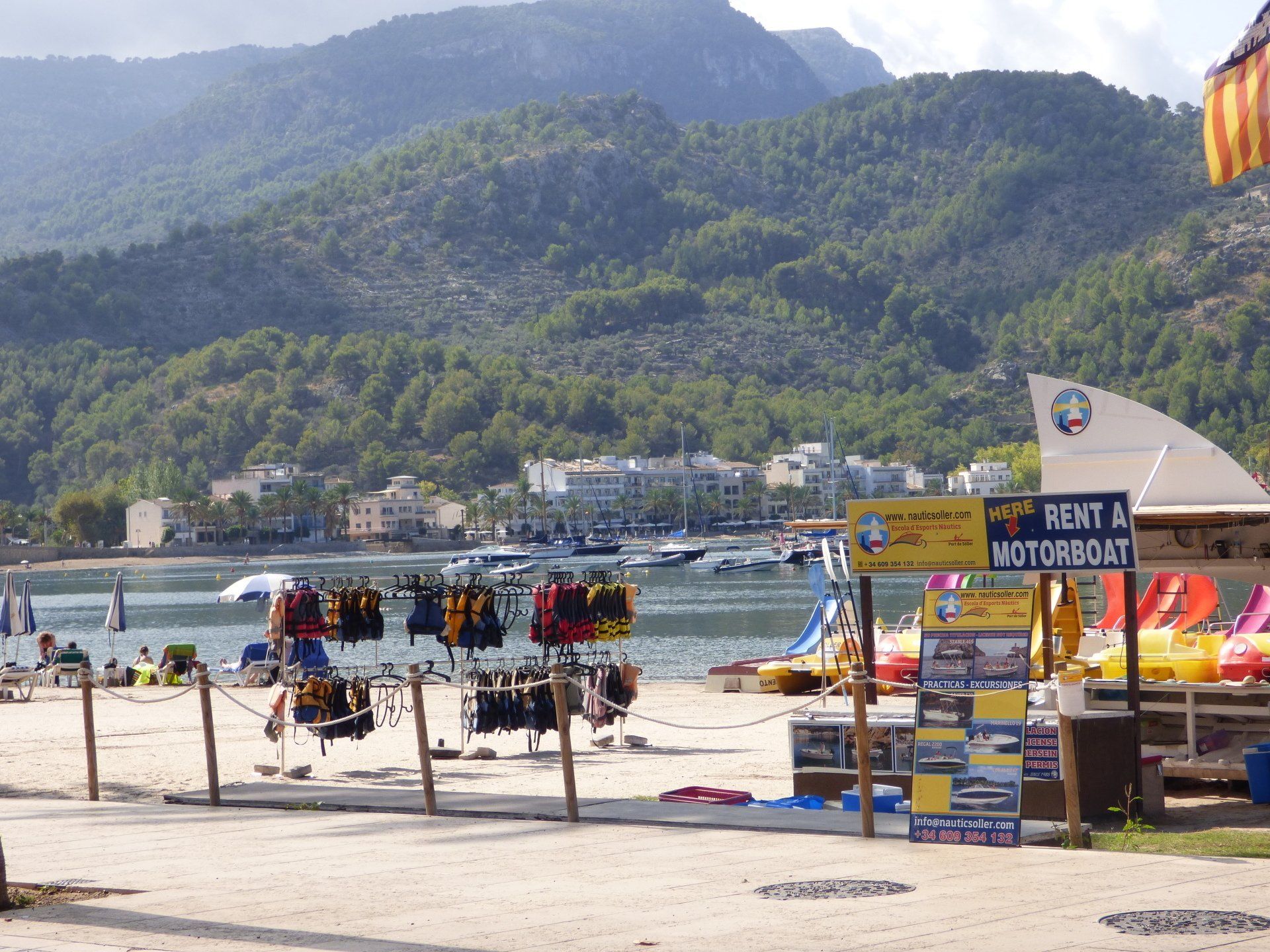 A beach with a sign that says rent a motorboat