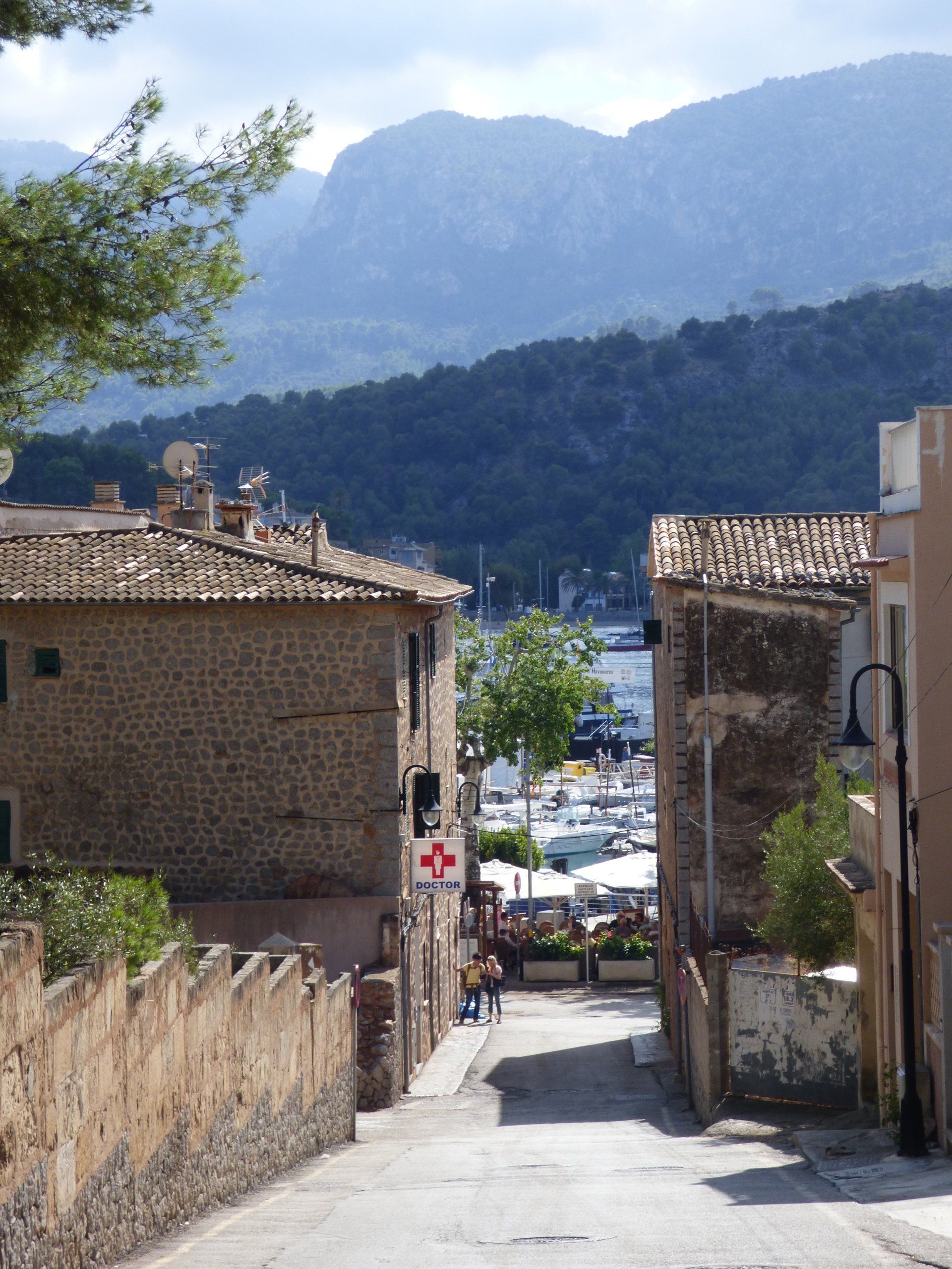 A red cross sign is on the side of a building