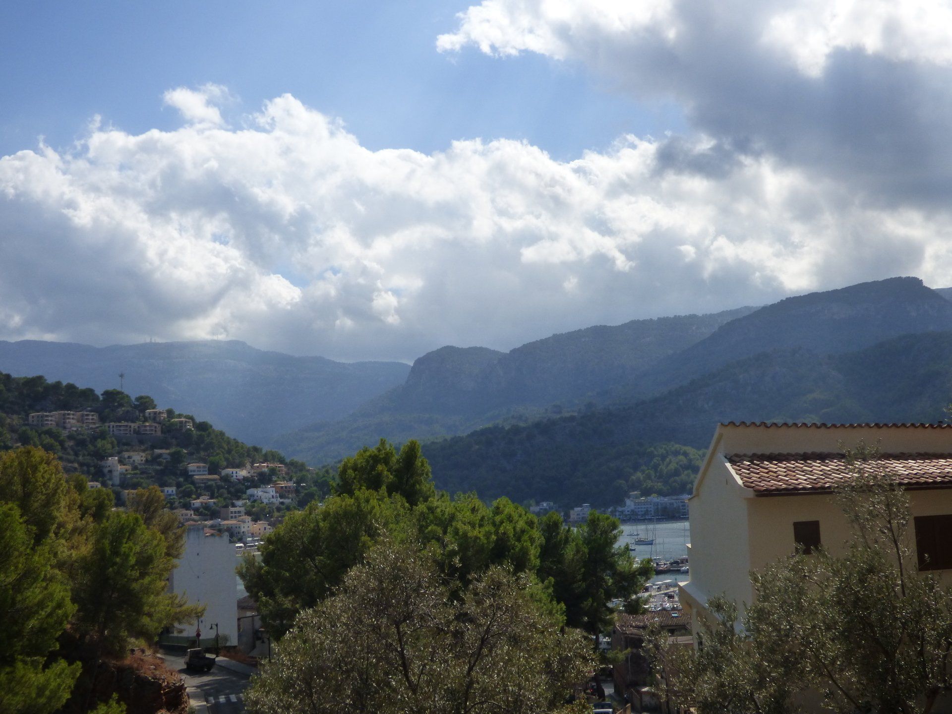 A view of a mountain range with a house in the foreground