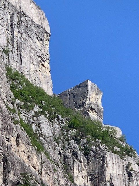 A large rock formation with a blue sky in the background
